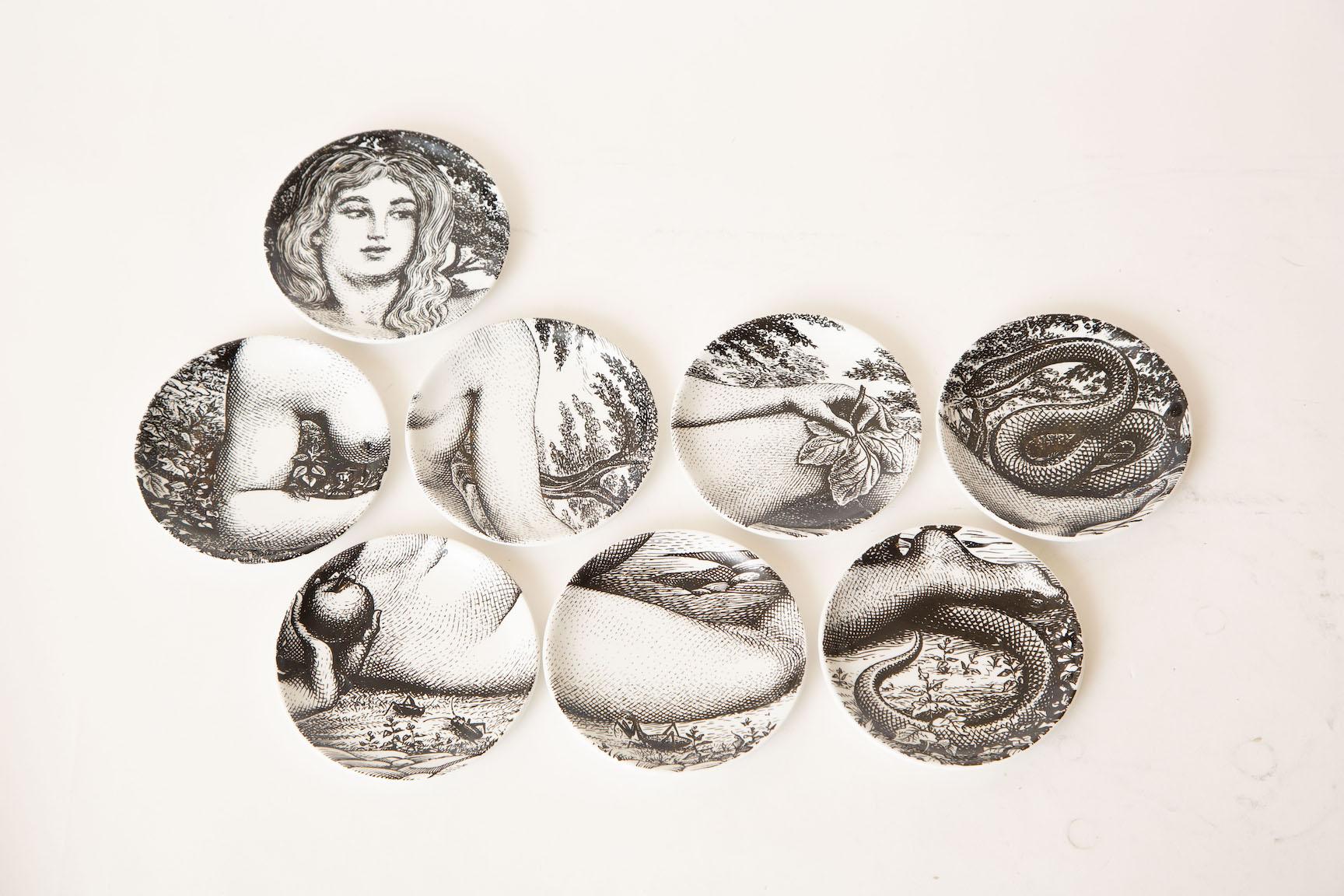 This vintage set of 8 Piero Fornasetti black and white porcelain coasters are the interplay of the creation of Eve as in Adam and Eve. They are Mid-Century Modern, Italian and all numbered and hallmarked on the back. Great barware. These can also be