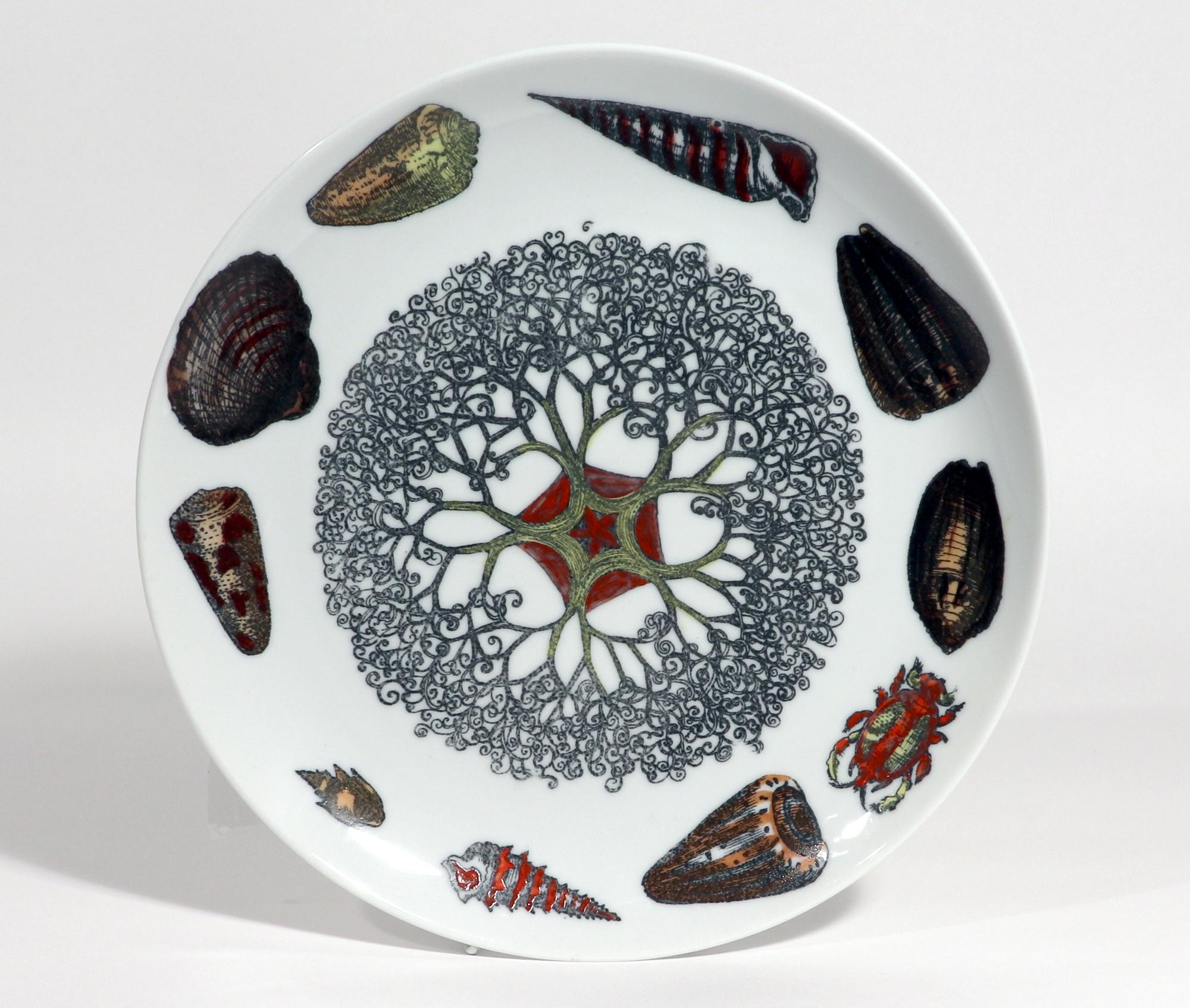 Piero Fornasetti Porcelain Conchiglie Seashell Plate With Snails and Mollusks,
#9,
Circa 1960s-70s
The Fornasetti plate is decorated in the Conchiglie pattern which depicts different sea shells and sea anemones. The plate is transfer printed and