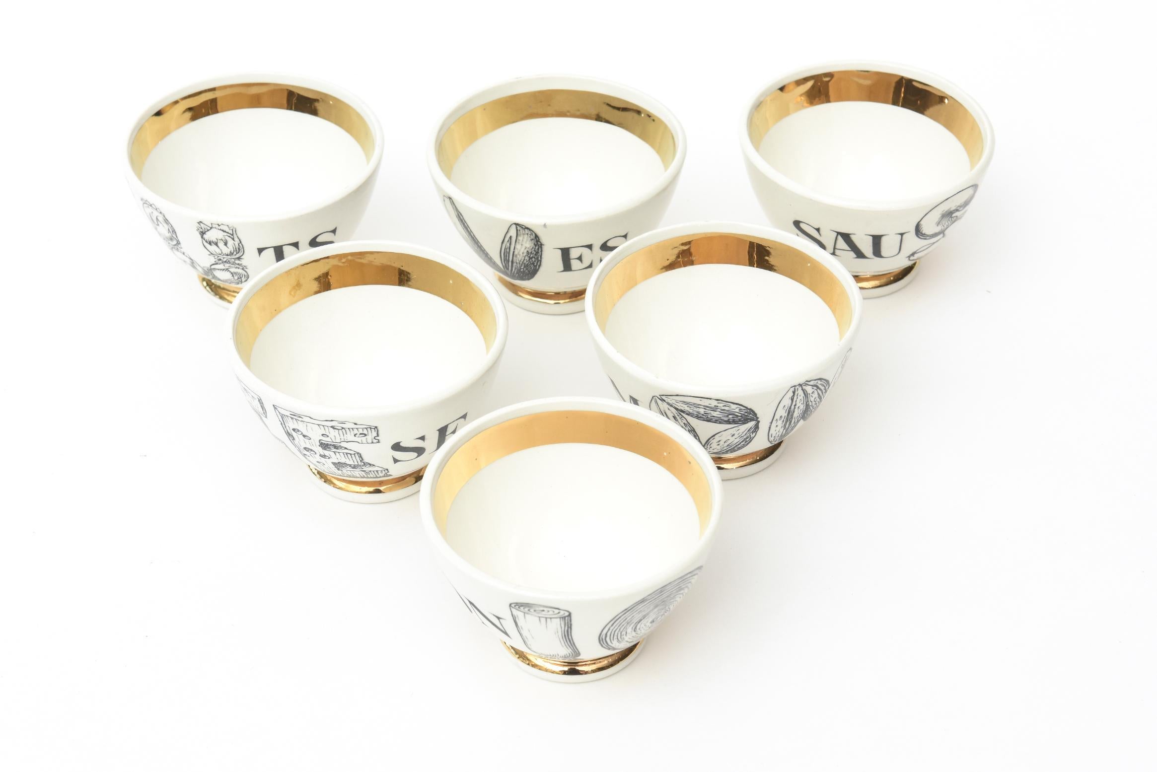 These fabulous small Mid-Century Modern Piero Fornasetti vintage appetizer small serving bowls are porcelain with gilded gold edges, bottom and insides. They are the complete set of 6 and are clever barware and serving pieces. The bowls are labelled