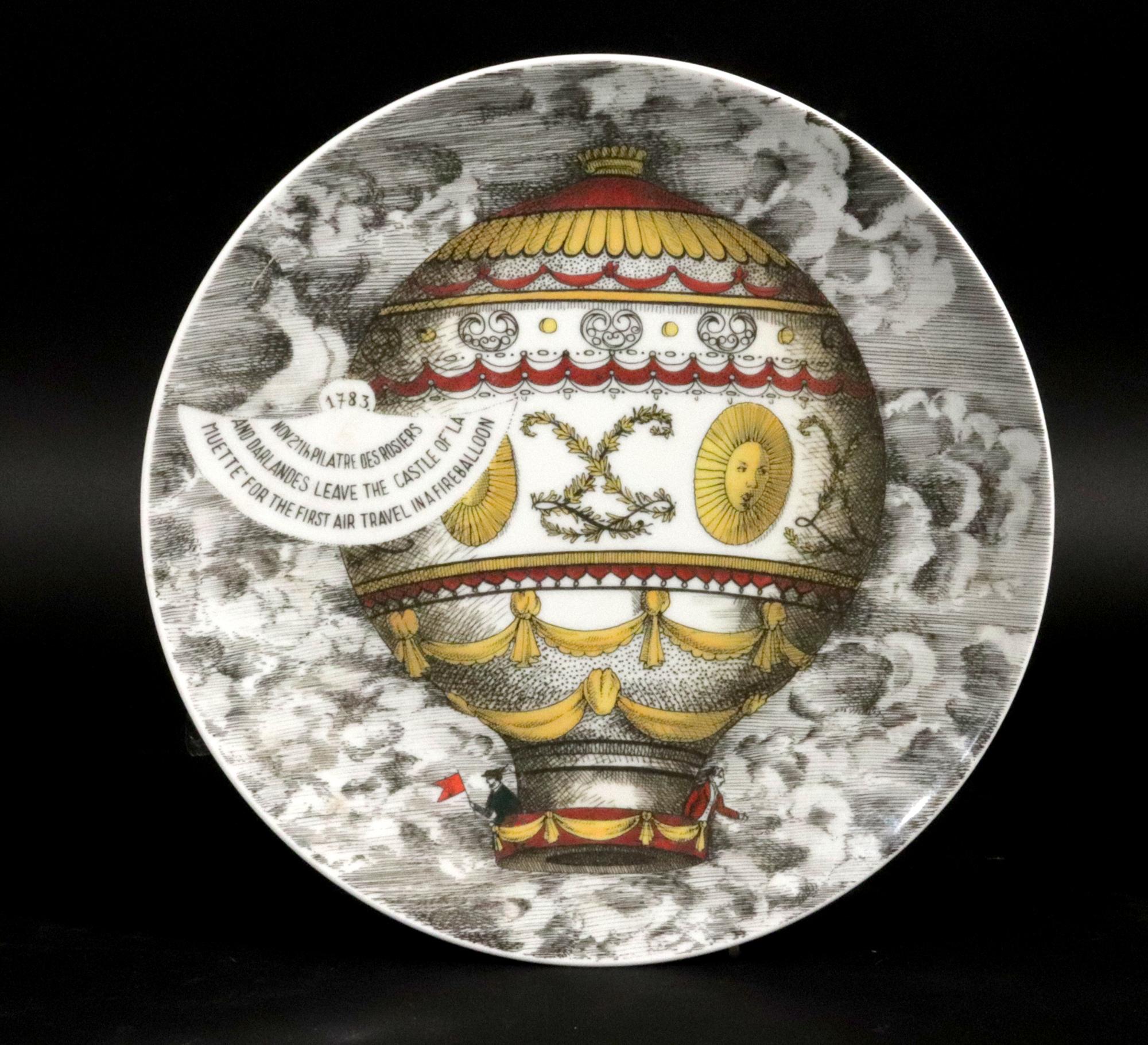 Piero Fornasetti Porcelain Hot Air Balloon Plates, 
Mongolfiere Pattern,
Rosenthal, Motiv 2,
1980s

The Piero Fornasetti porcelain plate was made by Rosenthal and depicts a scene of a historical hot air balloon. The pattern is known as the