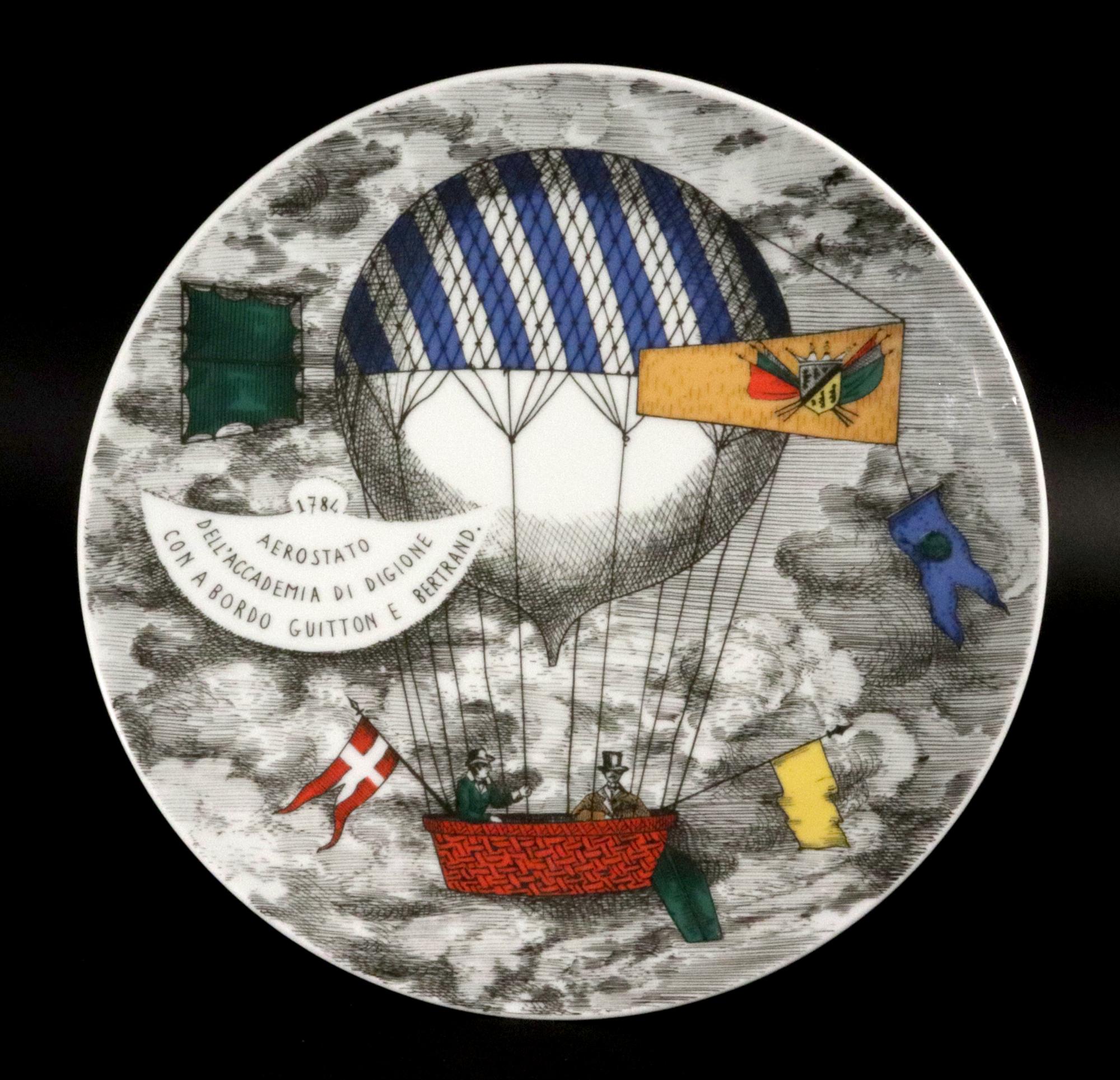 Piero Fornasetti Porcelain Hot Air Balloon Plates, 
Mongolfiere Pattern,
Rosenthal, Motiv 1,
1980s

The Piero Fornasetti porcelain plate was made by Rosenthal and depicts a scene of a historical hot air balloon. The pattern is known as the