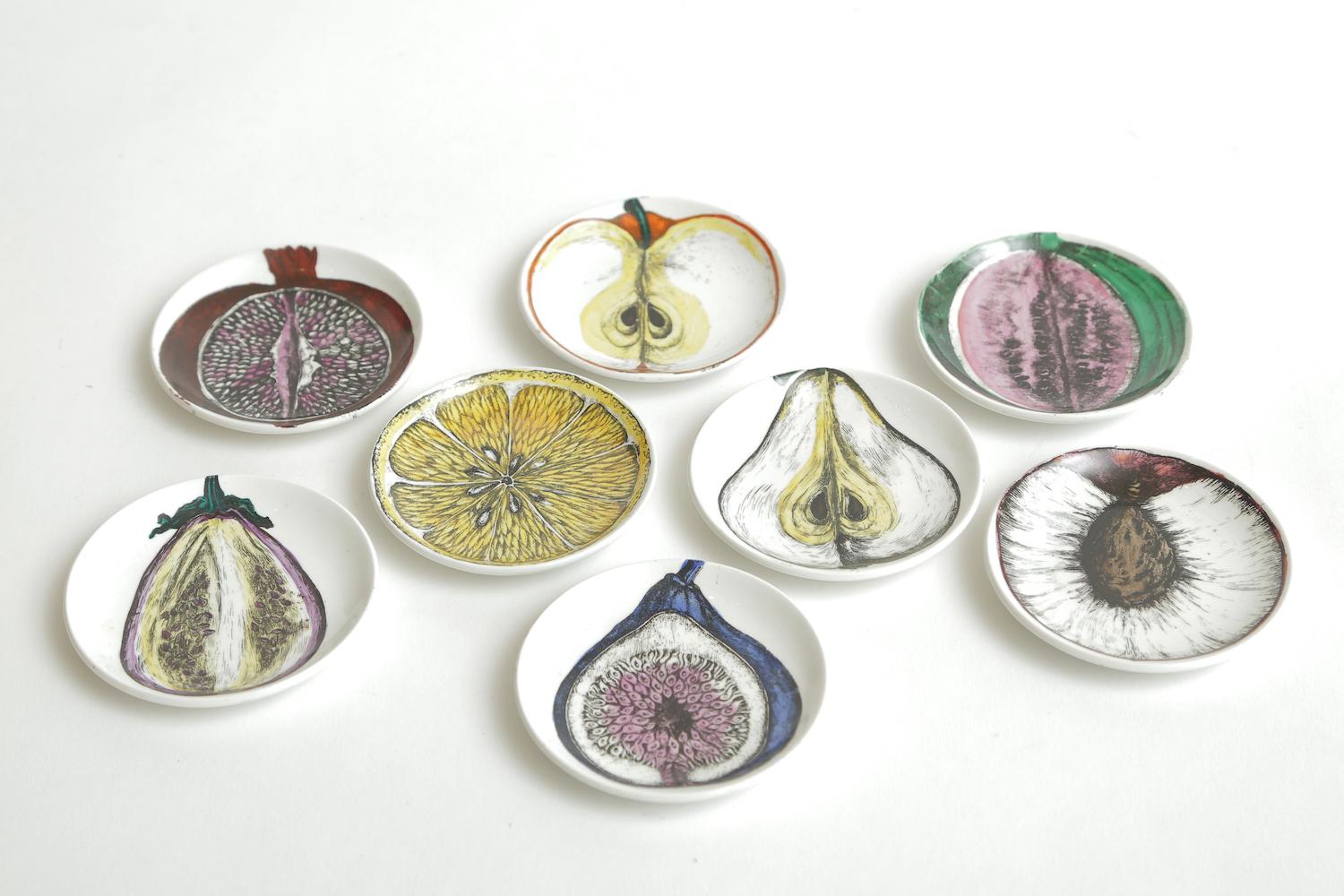 This very rare and perhaps never used complete set of 8 Italian Piero Fornasetti porcelain small plates or coasters are signed and titled Sezoni Di Frutta. They are Mid-Century Modern and in their original yellow box with the paper dividers from the