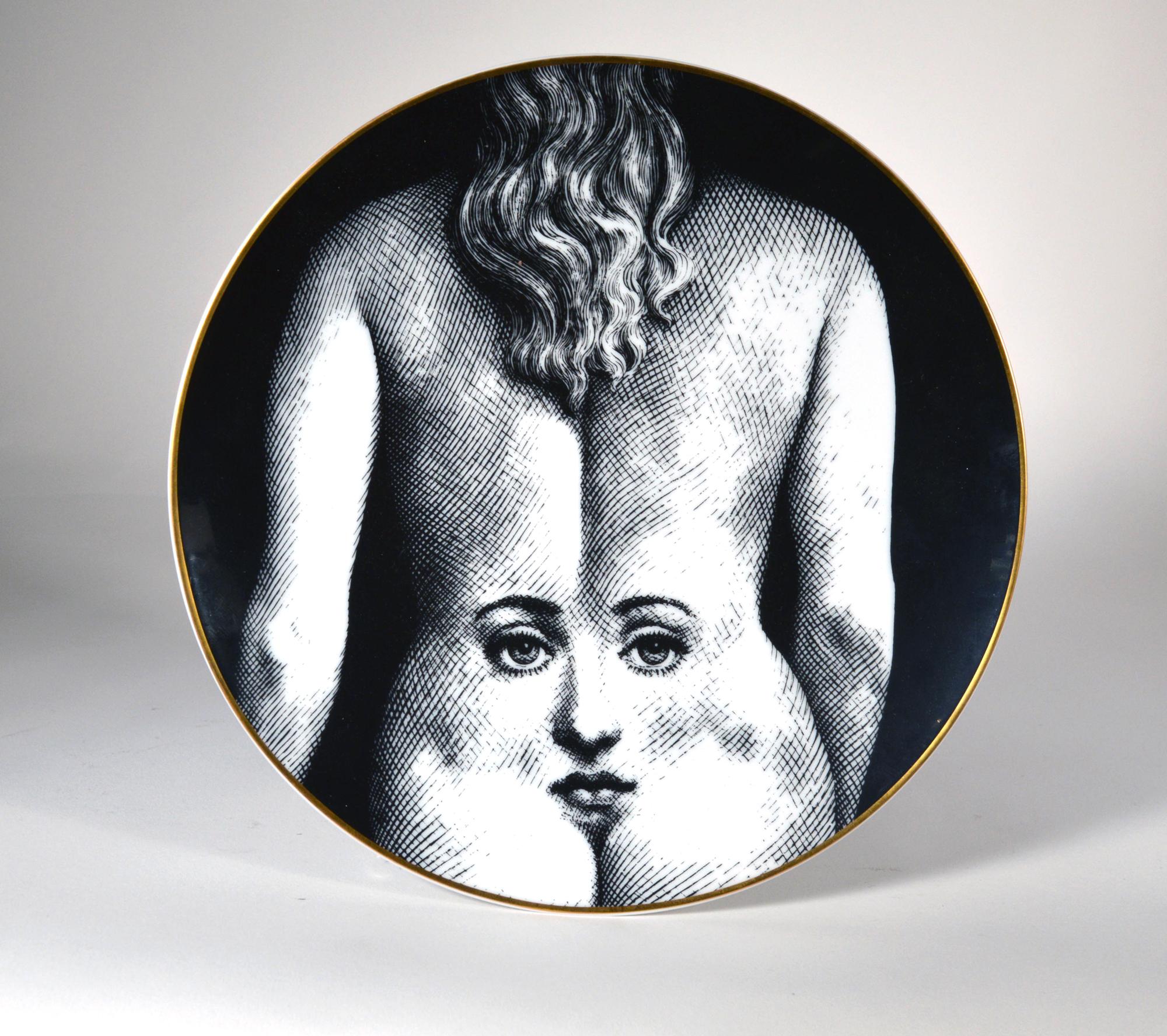 Piero Fornasetti Rosenthal Porcelain Themes And Variations Plate, 
Motiv Number 28,
1980s

The striking Rosenthal Fornasetti gold-rimmed black and white printed plate with the face of Lina Cavalieri depicted on the back of a Lady.

Dimension: