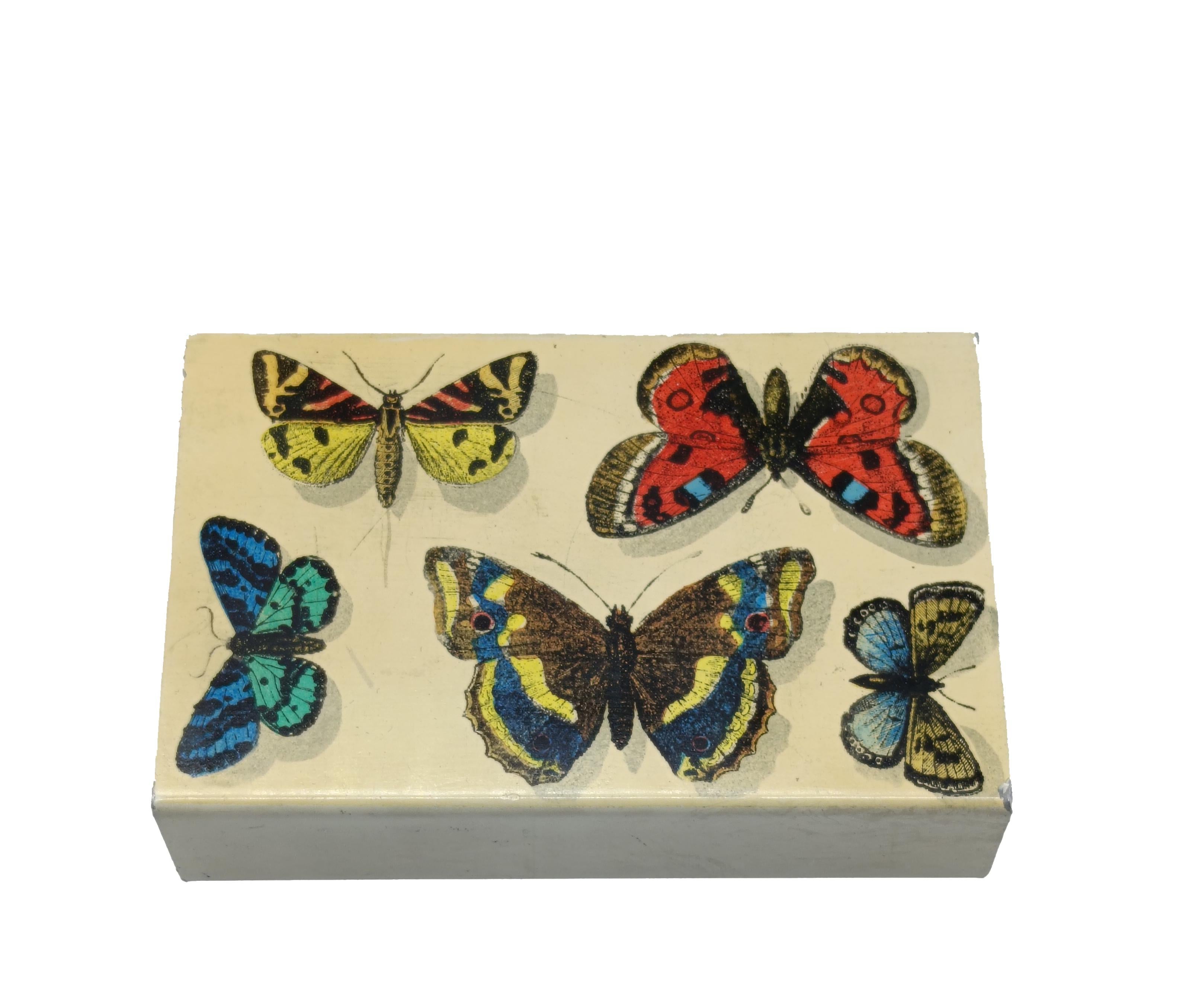 Original and decorative box from the 1960s designed by Piero Fornasetti, a celebrated Italian artist and designer known for his dreamlike and surreal approach to design. The box is rectangular, with sliding drawer structure. The exterior is painted
