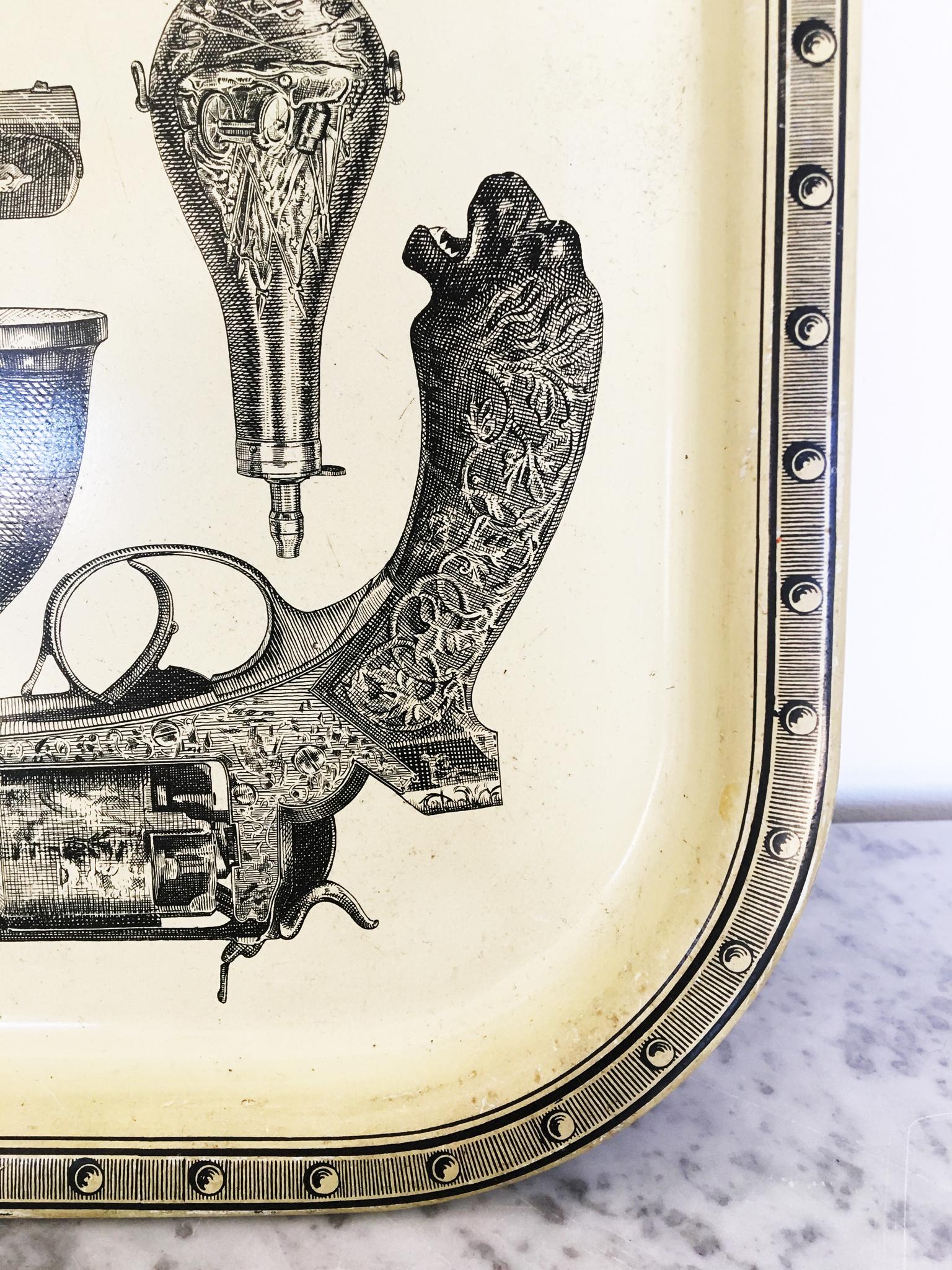 Maison Fornasetti 'Pistole' enamelled steel serving trays featuring a cool and quirky print of antique pistols and guns. The underside is a printed wood effect. Some user marks.
Two trays available.
Italian, circa 1960.

Size 33 x 33 cms

The