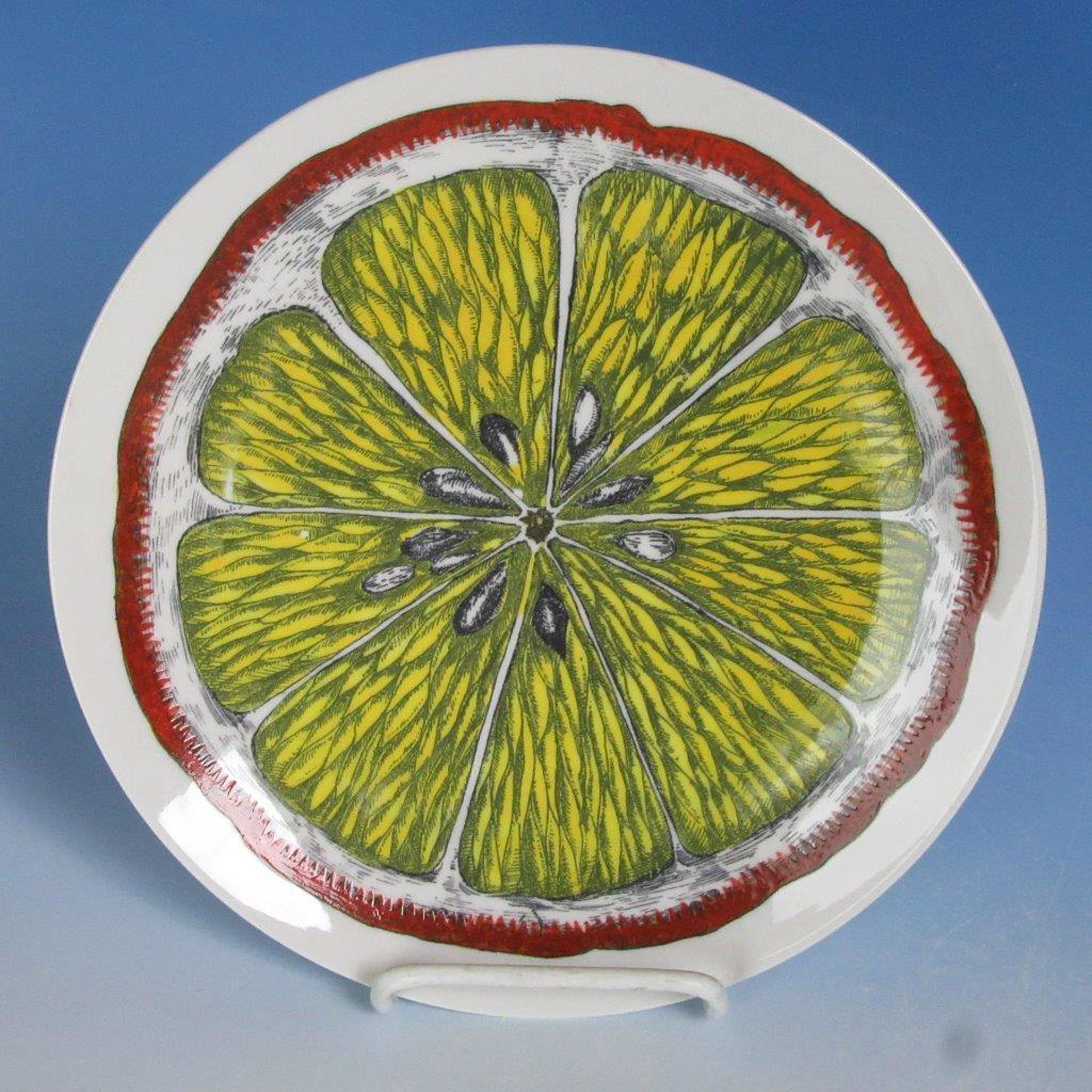 Piero Fornasetti Sezioni Frutta plate, 
#1, 
1970s-1980s.
The plate depicting a sliced fruit.
Measures: Diameter 9 1/2 inches.