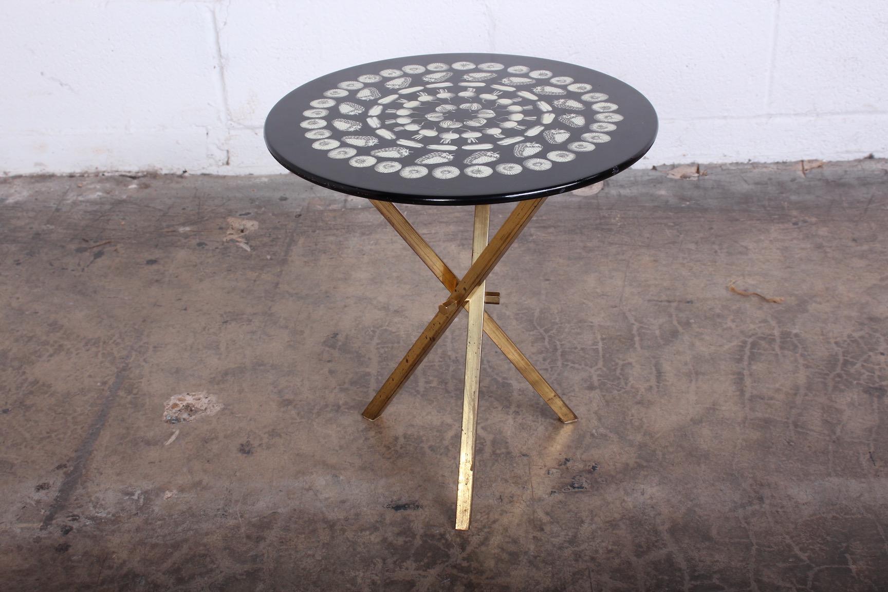 Side table with brass base designed by Piero Fornasetti, 1960s.