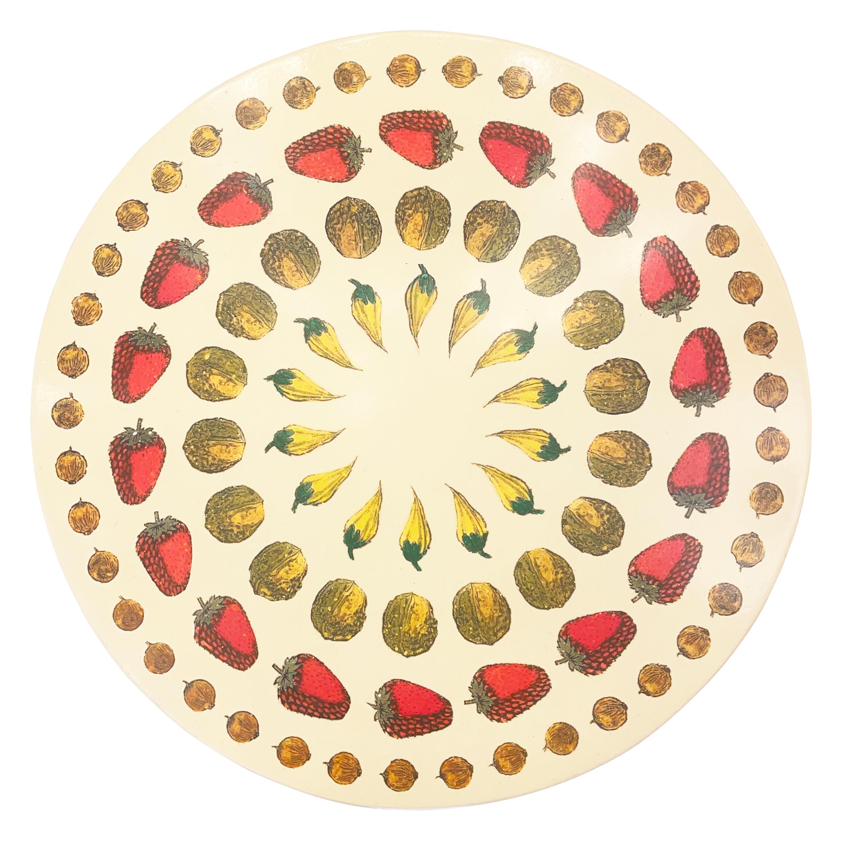 Italian Mid-century Piero Fornasetti side table, featuring a colorful concentric motif of fruit and nuts on an off-white background. Brass tripod base.

Condition: Excellent vintage condition, minor wear consistent with age and use.

Measures: