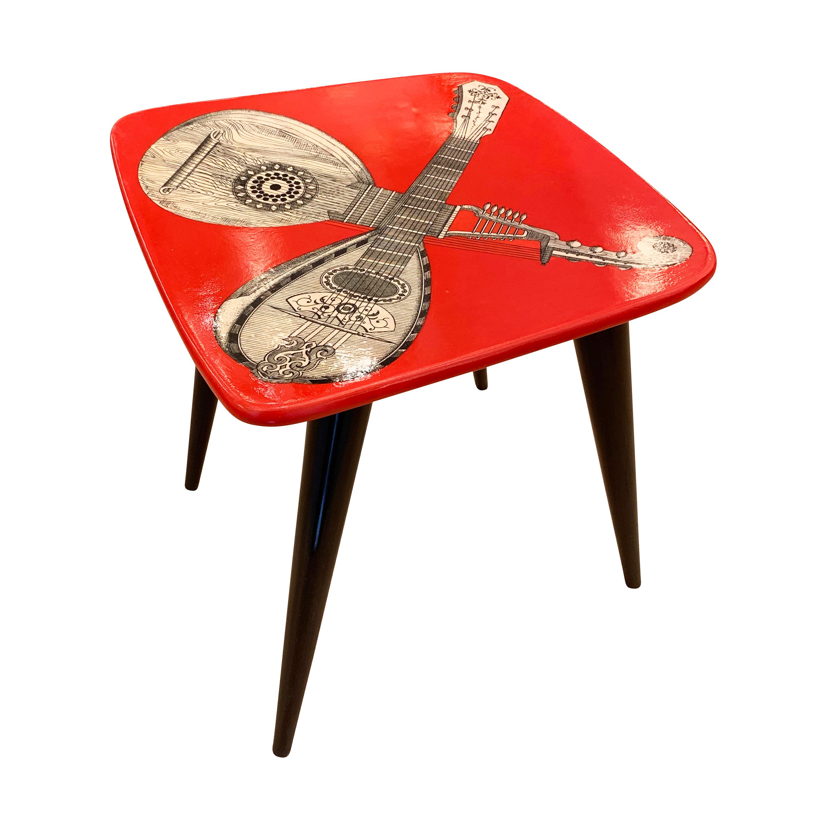 1950s Piero Fornasetti stool with a musical motif on a red background. Only about 60 were ever made and it was never re-edited adding to its rarity.

Condition: Excellent vintage condition, minor wear consistent with age and use.

Measures: