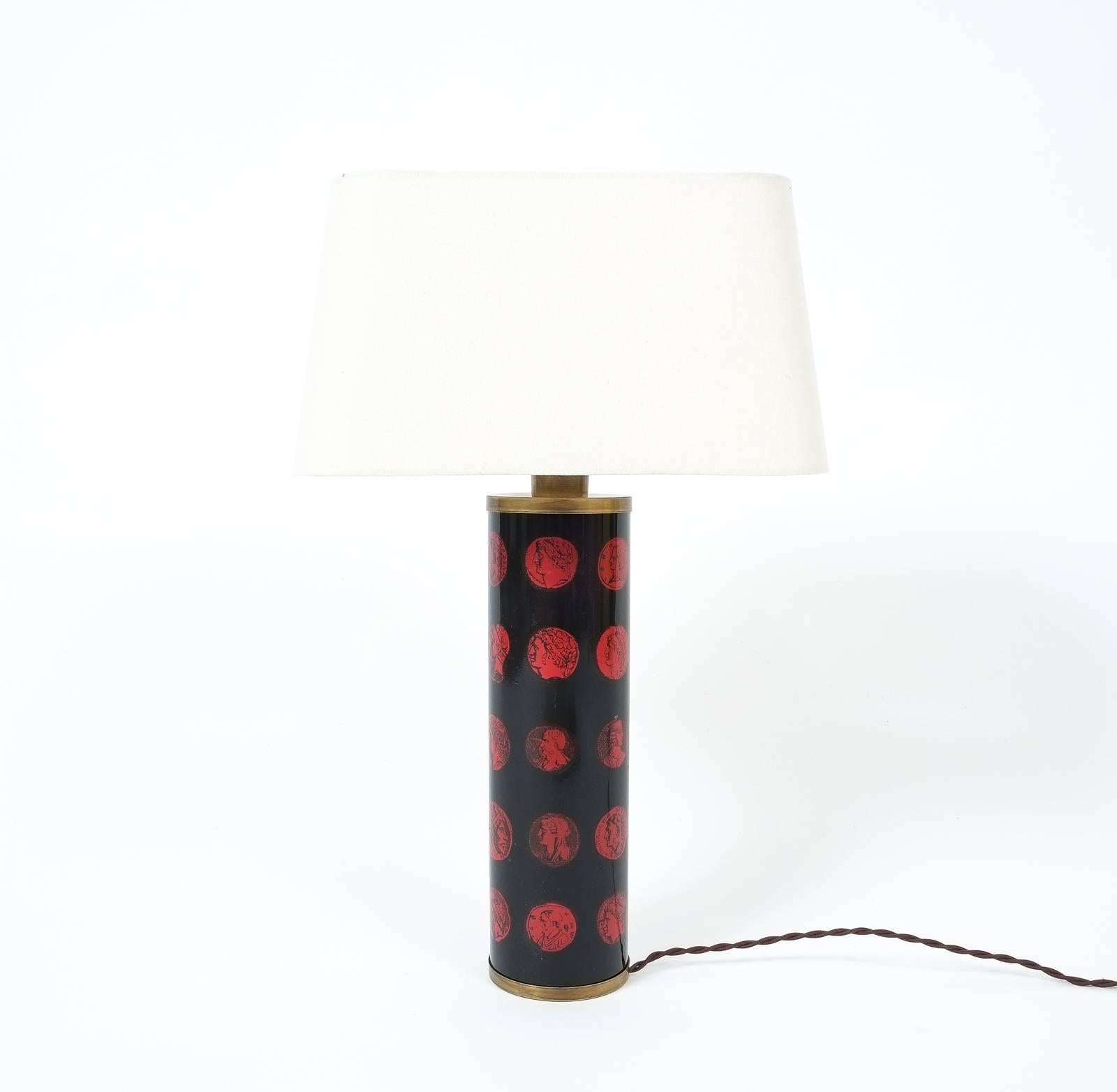 Graphical desk lamp painted by Piero Fornasetti

Beautiful Piero Fornasetti table lamp (Cameo), circa 1960, Italy, comprised of painted metal decorated with emperors (lithographical and transfer-printed) and patinated brass. The original print is