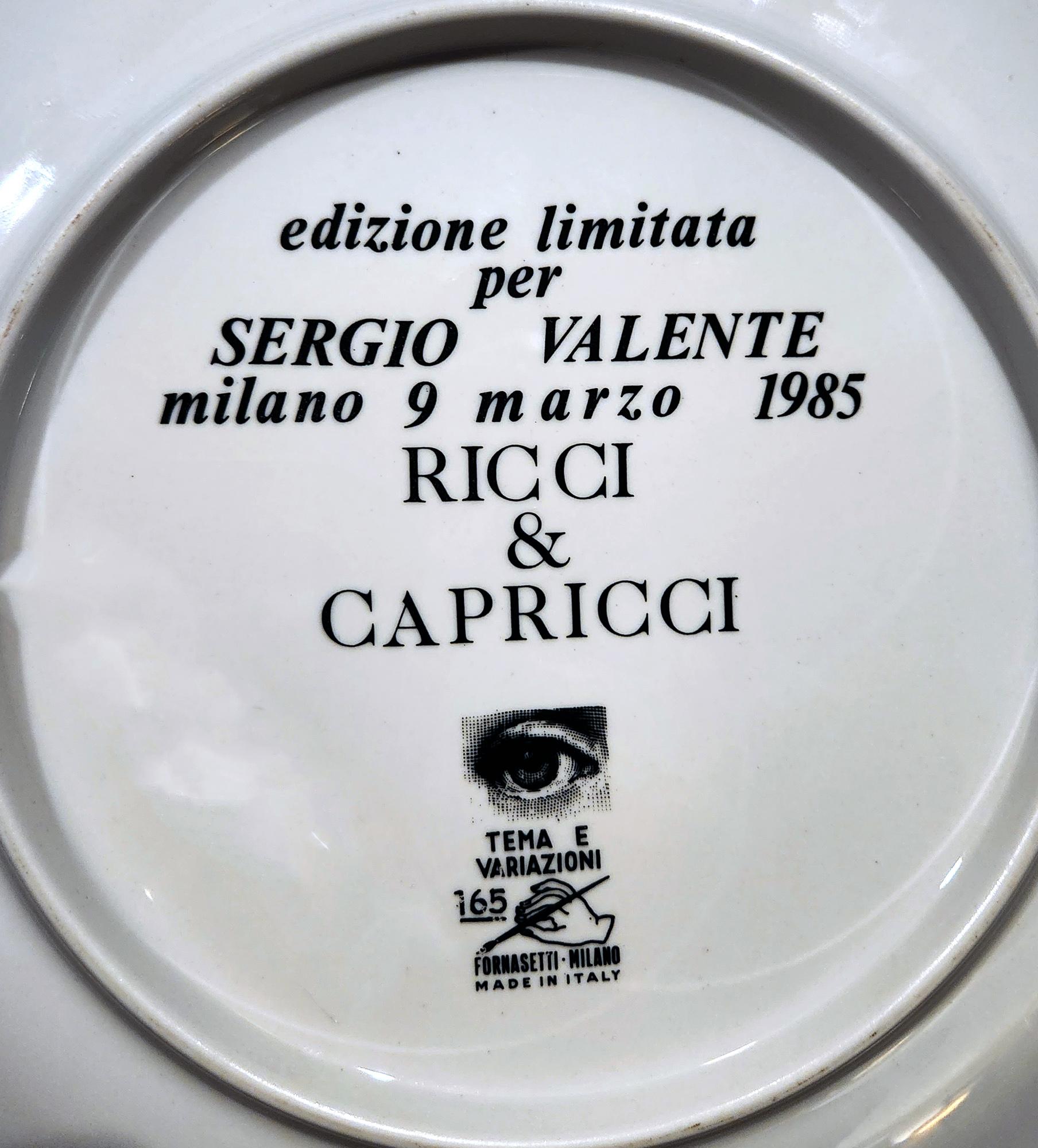 Piero Fornasetti Themes & Variation Porcelain Plate, #165
Special Limited Edition for Sergio Valente,
Dated 9 March 1985

A large Piero Fornasetti plate made as a special edition with pattern number 165- a series of roundels of the face of the