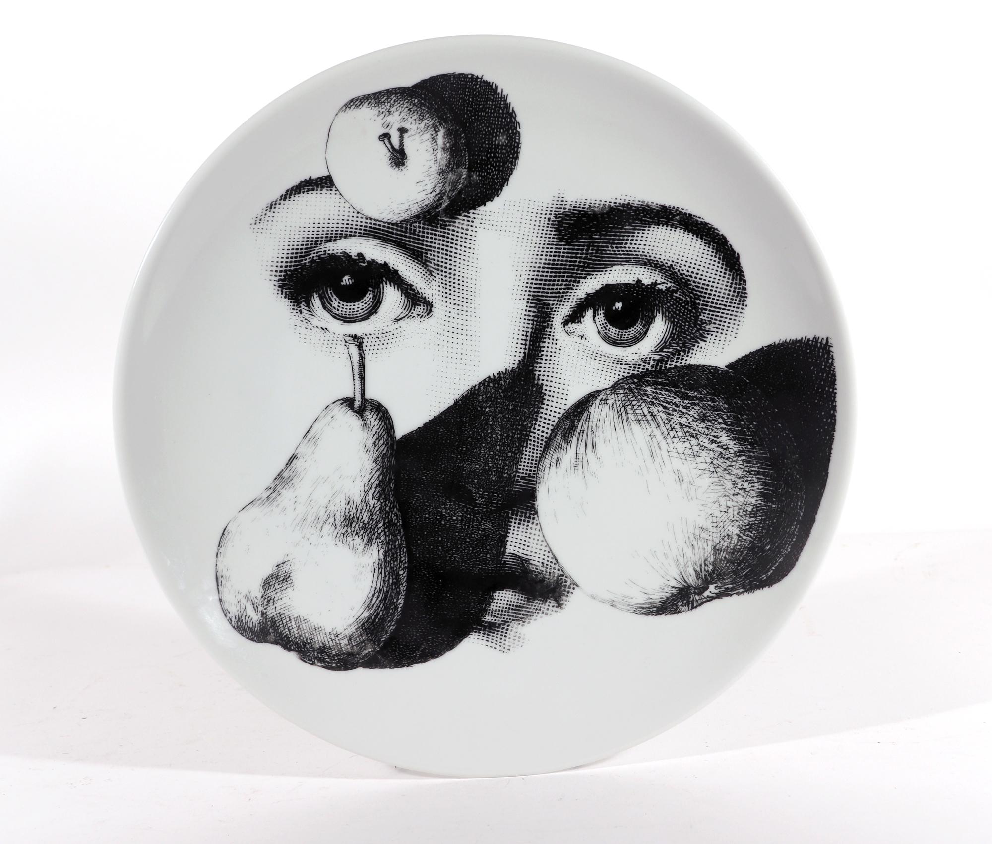 Piero Fornasetti Themes & Variations porcelain plate,
#218,

The Piero Fornasetti Porcelain plate is decorated with pattern number 218 of the Themes & Variation pattern which is a surreal take on the series with the face of Lina Caratelli with