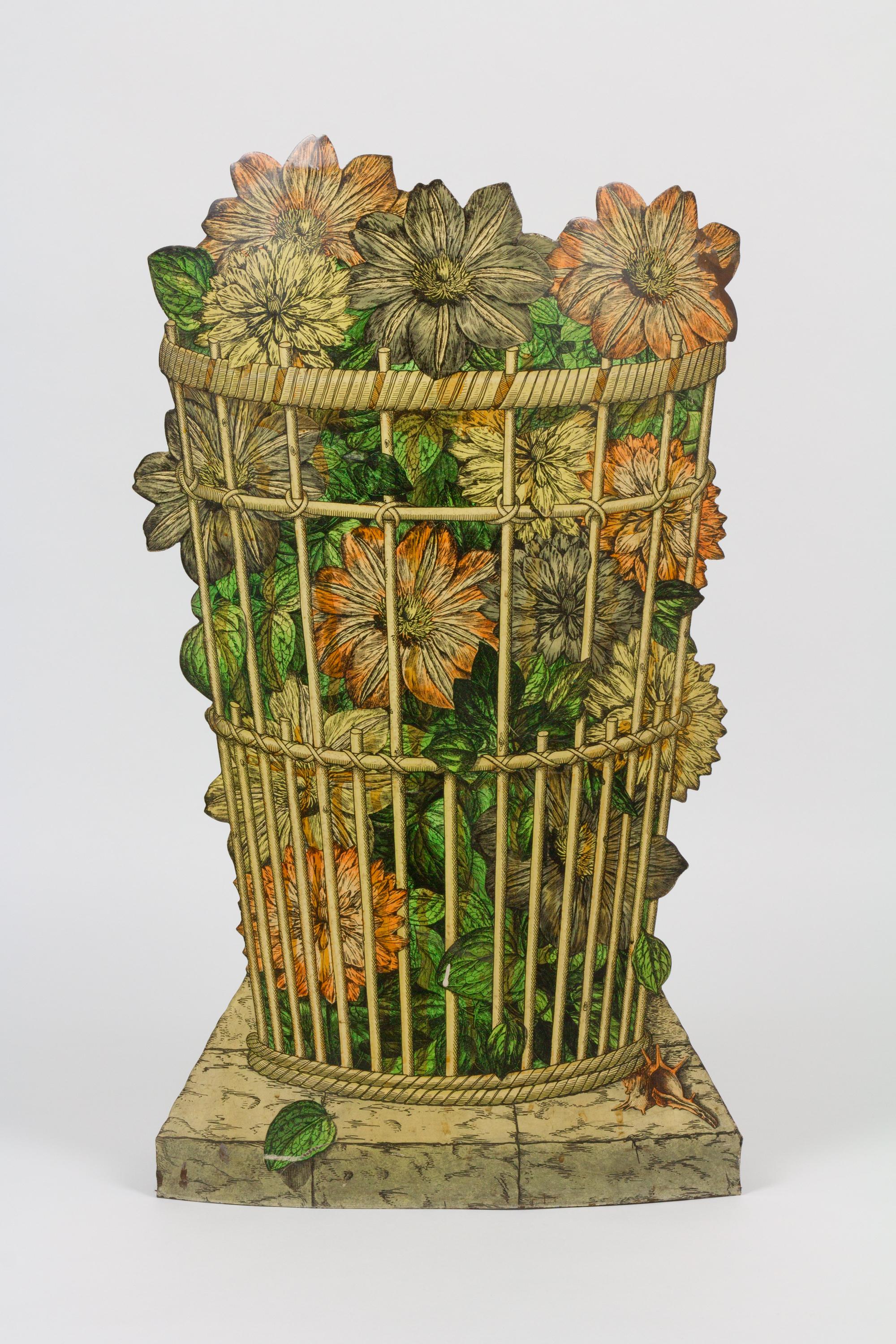 Umbrella stand depicting a basket of flowers in trompe l'oeil by Piero Fornasetti. Hand-painted and lithographic transfer-printed on steel. Retains removable tray and label.