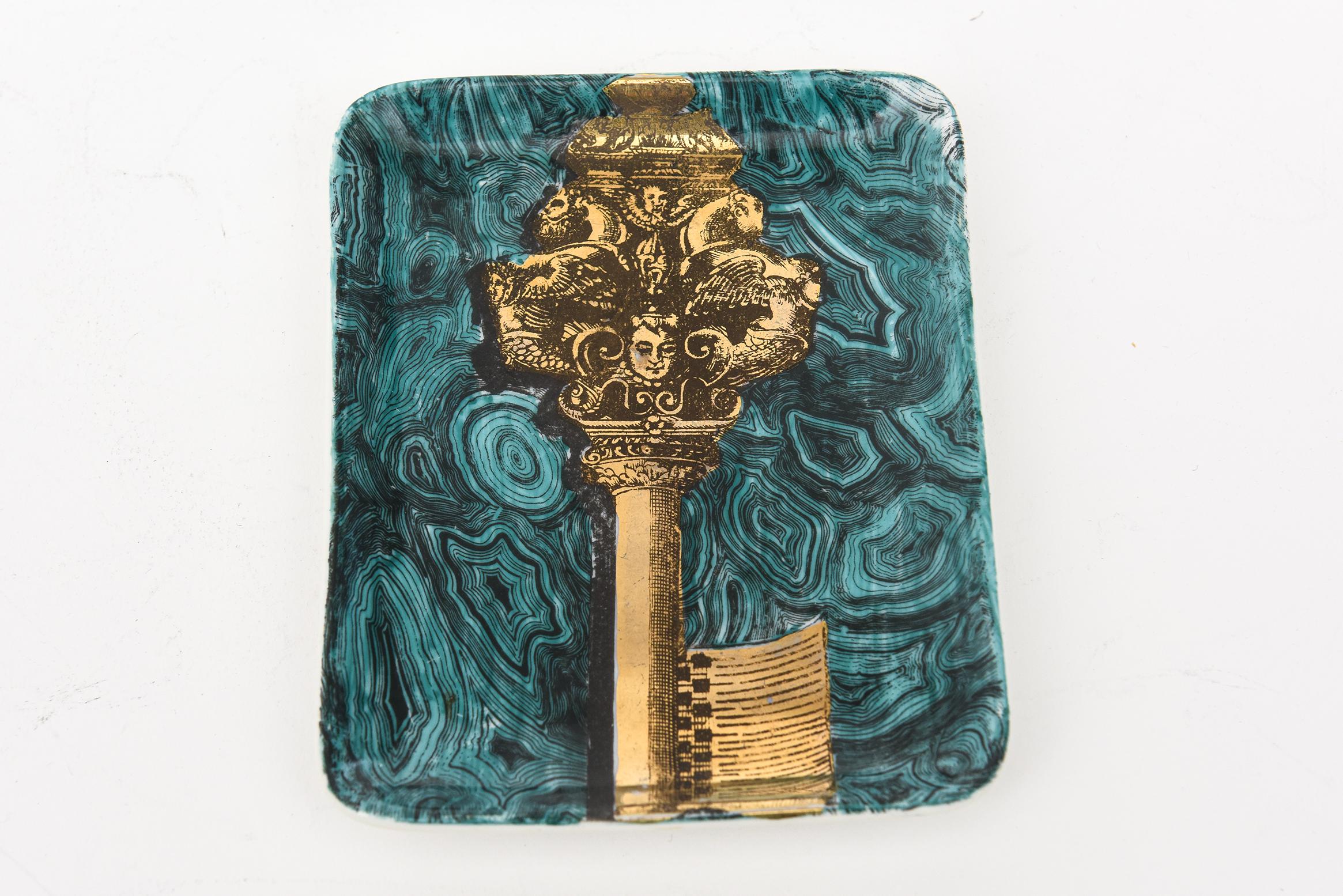 This unusual vintage Piero Fornasetti small porcelain tray or dish has the motif and subject matter of a gilded key amongst swirls of faux teal green turquoise malachite. This is a great ring or small tray and from the 50's. Signed and hallmarked