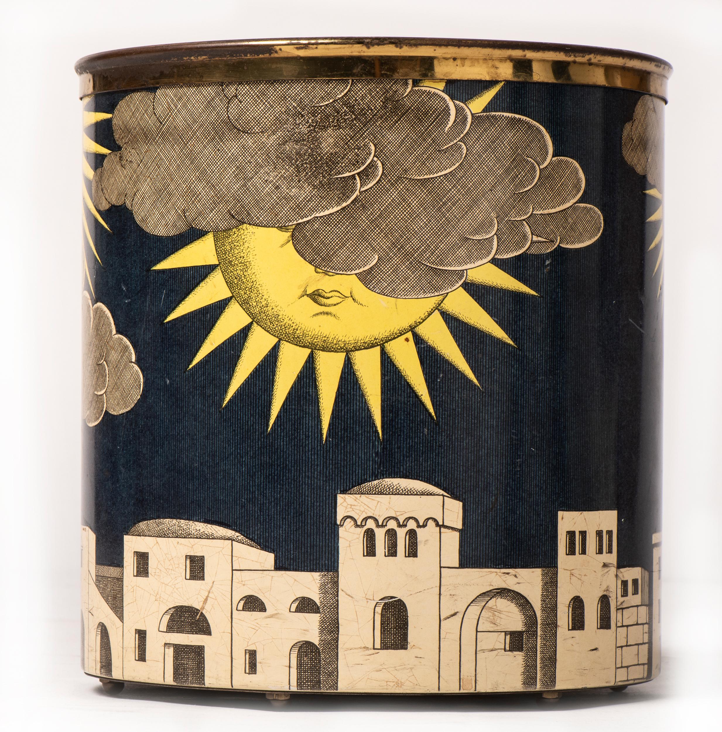 Piero Fornasetti waste paper bin.
“Sole de Capri”
Metal lithographically printed and hand coloured.
Mark to base.
Italy,
circa 1960.
Measures: 28 cm high x 26 cm diameter.
  