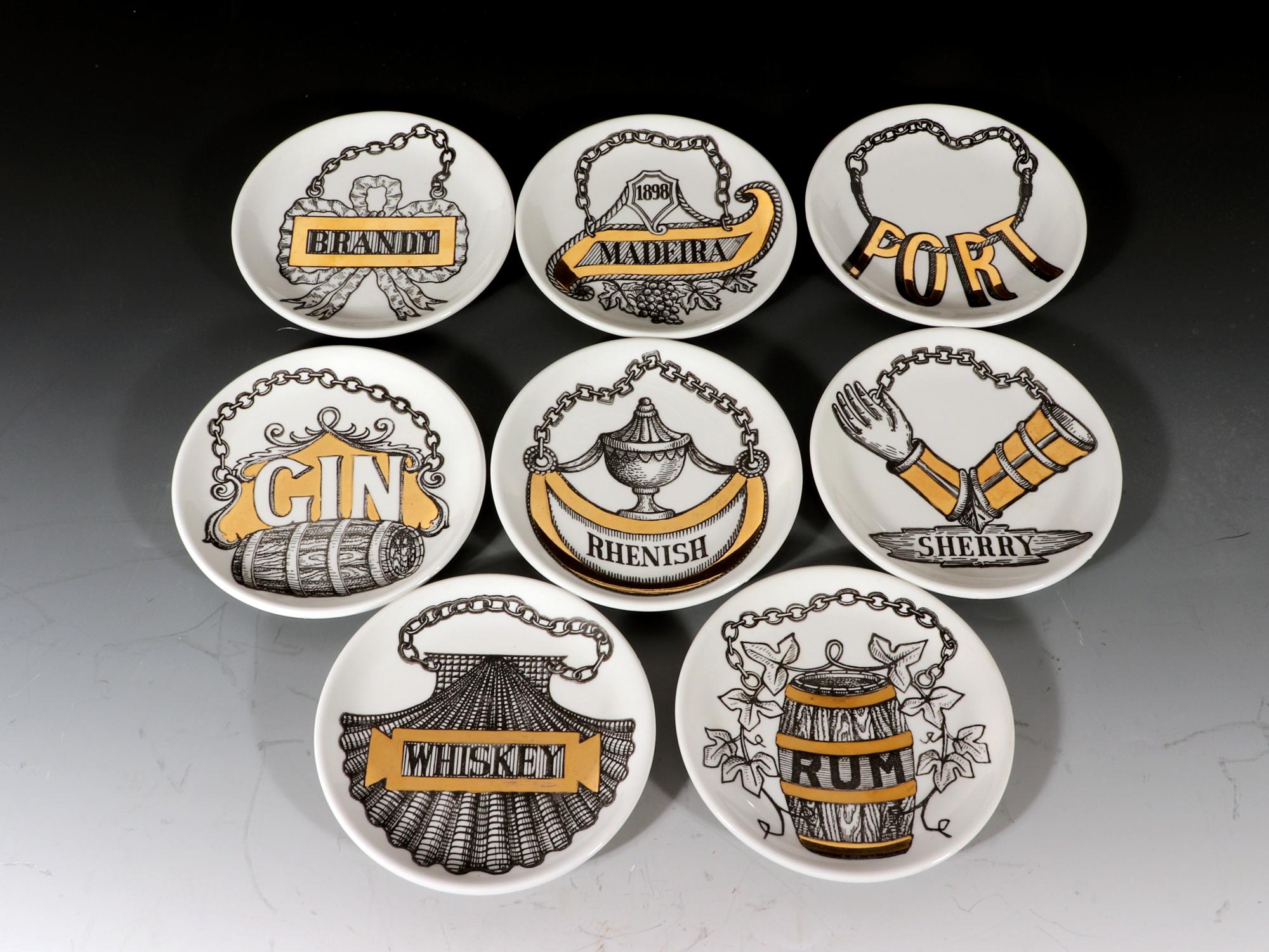 Piero Fornasetti wine & liquor coasters,
Vini E Liquori,
With Original Gold Box,
1960's.

The charming complete set of coasters with their original gold box are named Gin, Rum, Sherry, Madeira, Port, Rhenish, Brandy, and Whiskey. Each coaster