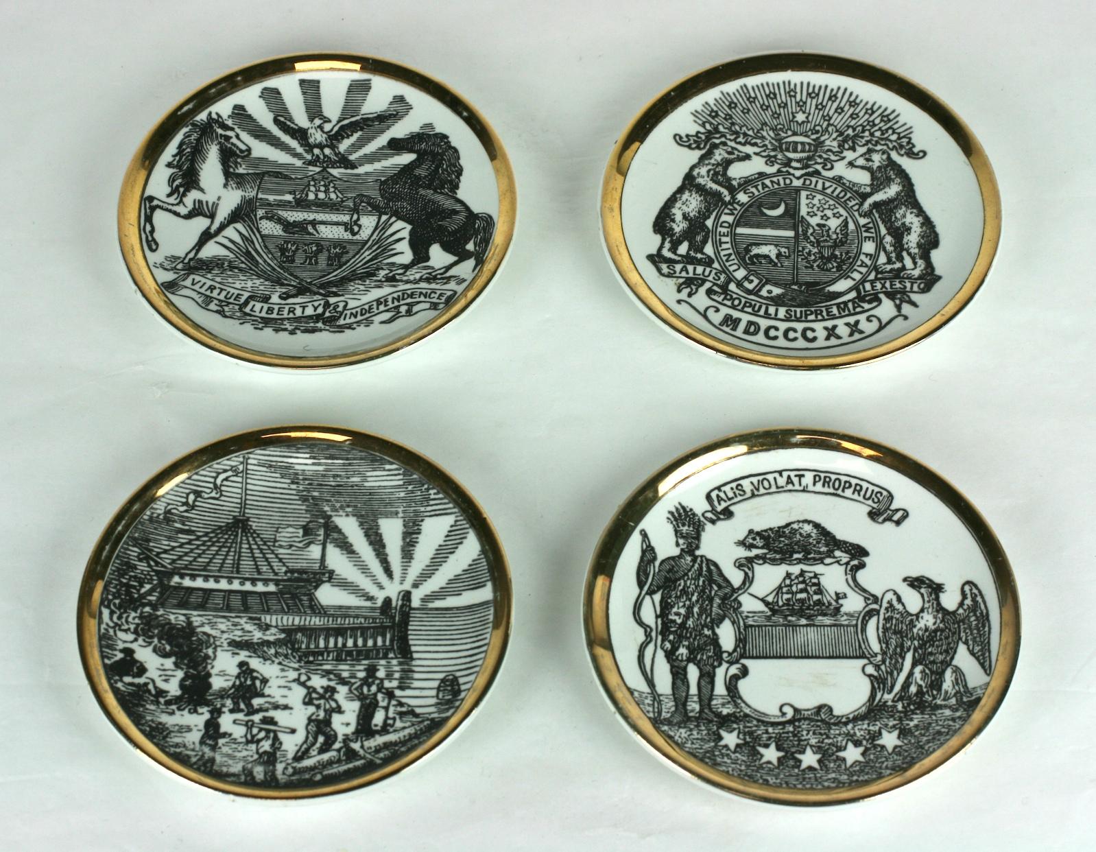 Piero Fornesetti's 8 piece coaster set with the emblems of various states in the US. Gilt decorated with lithographs of states emblems. Midcentury, Signed Fornesetti. 1950s Italy. 
Measures: 4
