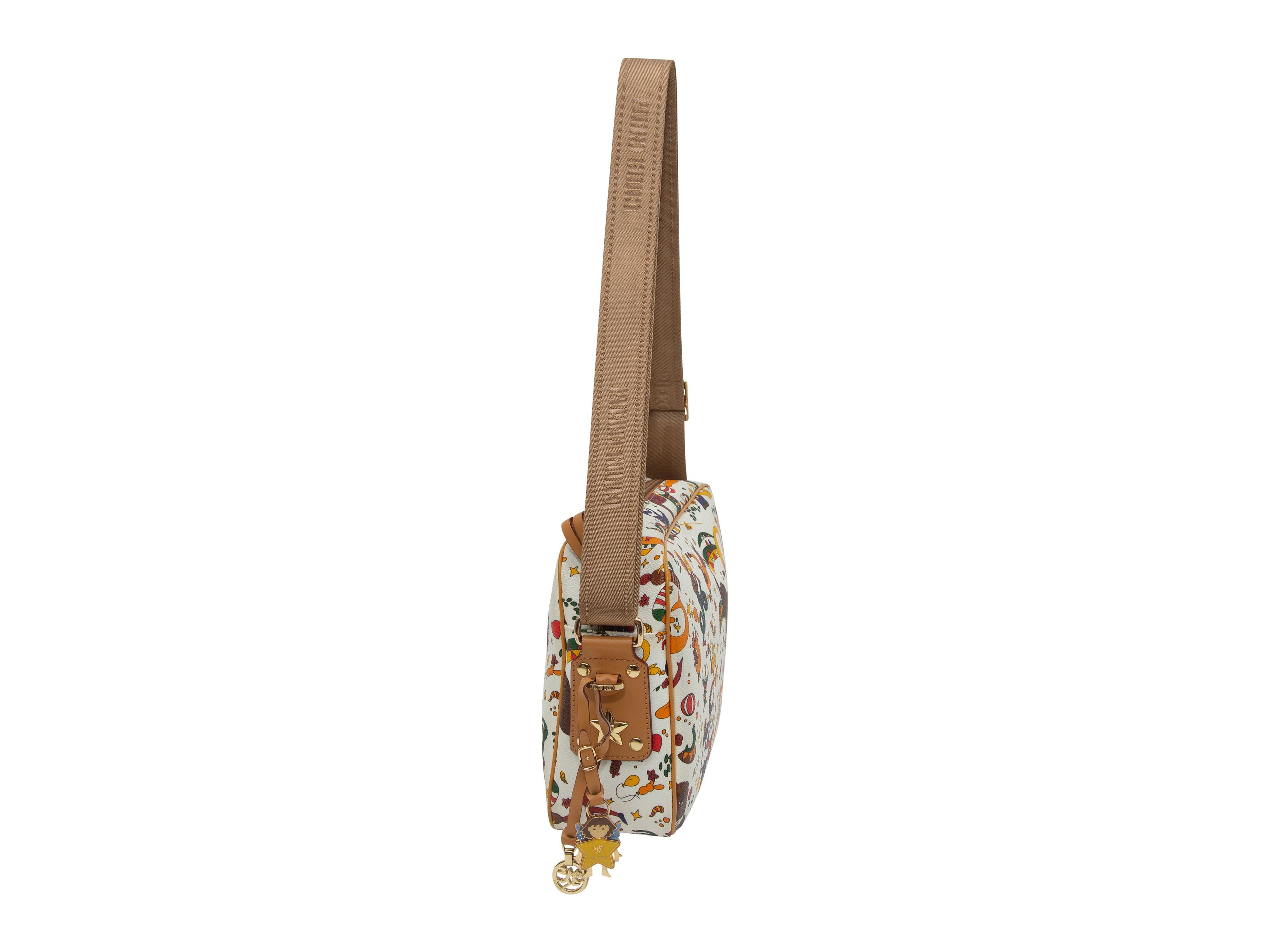 Product details: White and multicolor Magic Circus print leather crossbody bag by Piero Guidi. Tan leather trim throughout. Gold-tone hardware. Adjustable strap. Zip closure at top. 10