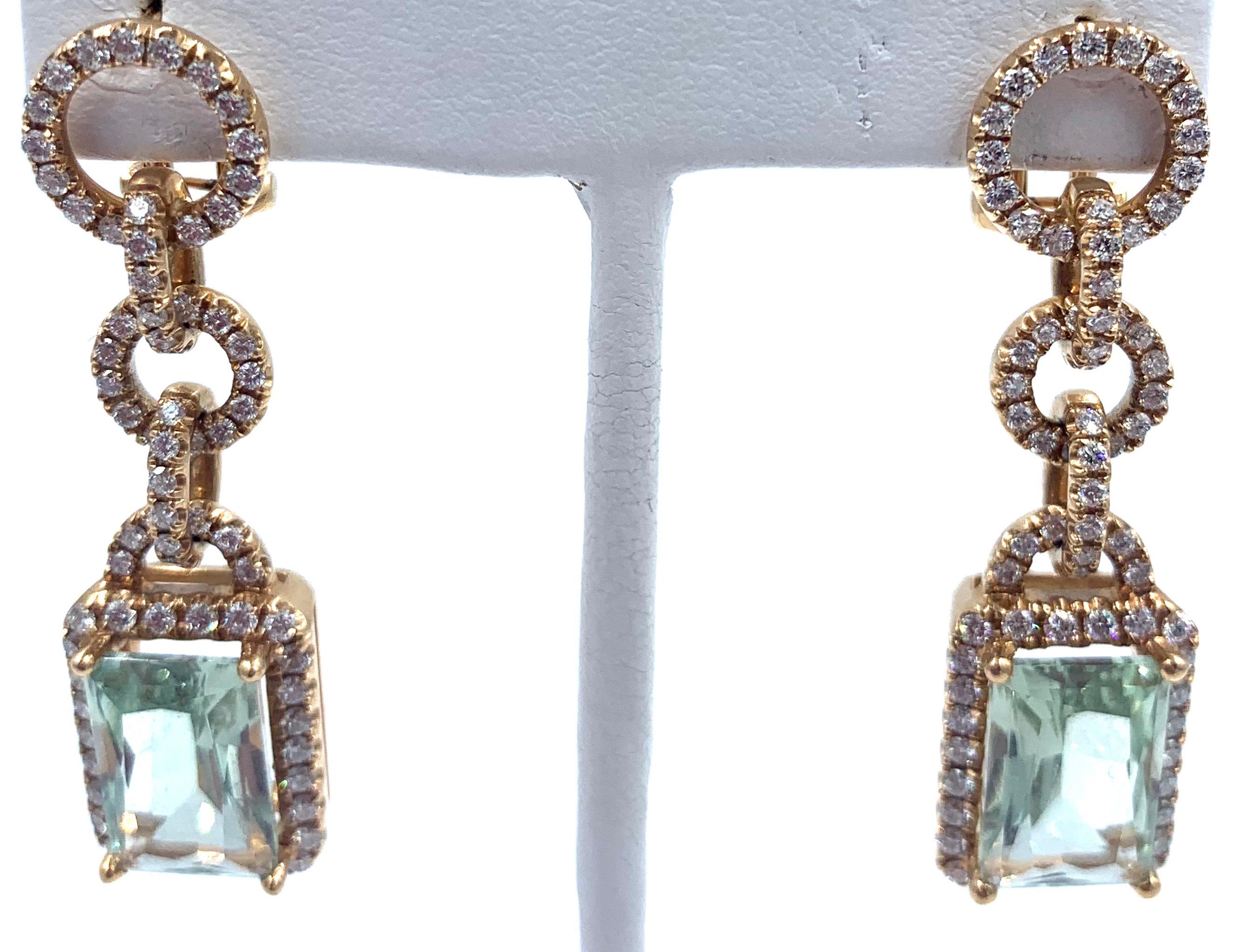 Stunning diamond and aquamarine earrings, set in 18 kt rose gold. Designed by the famed Italian jeweler Piero Milano, these earrings are a combination of beauty and elegance.  An emerald cut aquamarine, surrounded by diamonds, is suspended from