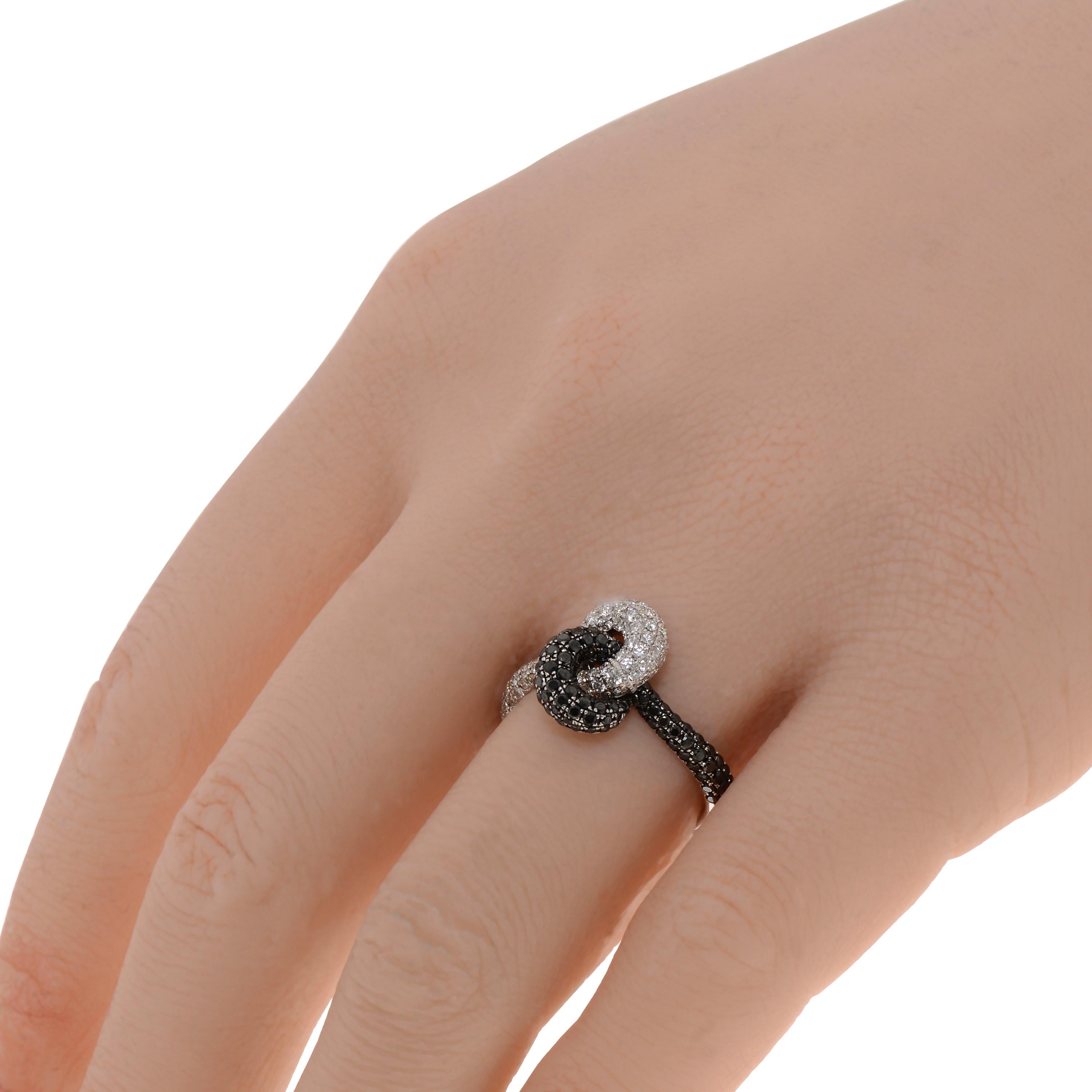 This spectacular Piero Milano 18K White Gold and 18K Black Gold Knot Ring features luscious black 0.73ct. tw. and white diamonds 0.66ct. tw. twisted into a delicate knot. The ring size is 6.5 (53.1). The Decoration Size is 12.7mm x 8.6mm. The Weight