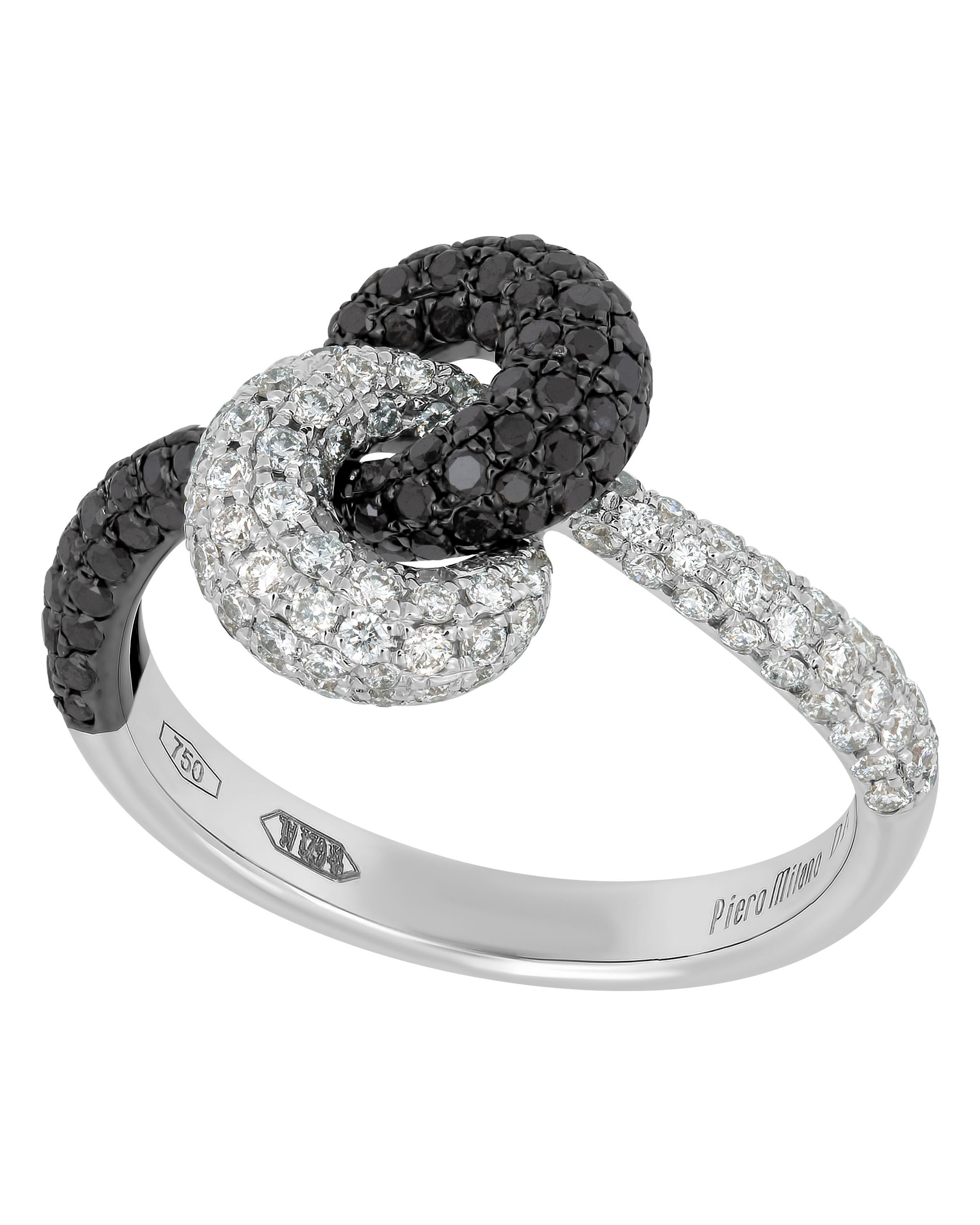 This spectacular Piero Milano 18K White Gold and 18K Black Gold Knot Ring features luscious black (0.69ct twd) and white diamonds (0.63ct twd) twisted into a delicate knot. The ring size is 6.75 (53.8). The Decoration Size is 12.7mm x 8.6mm. The