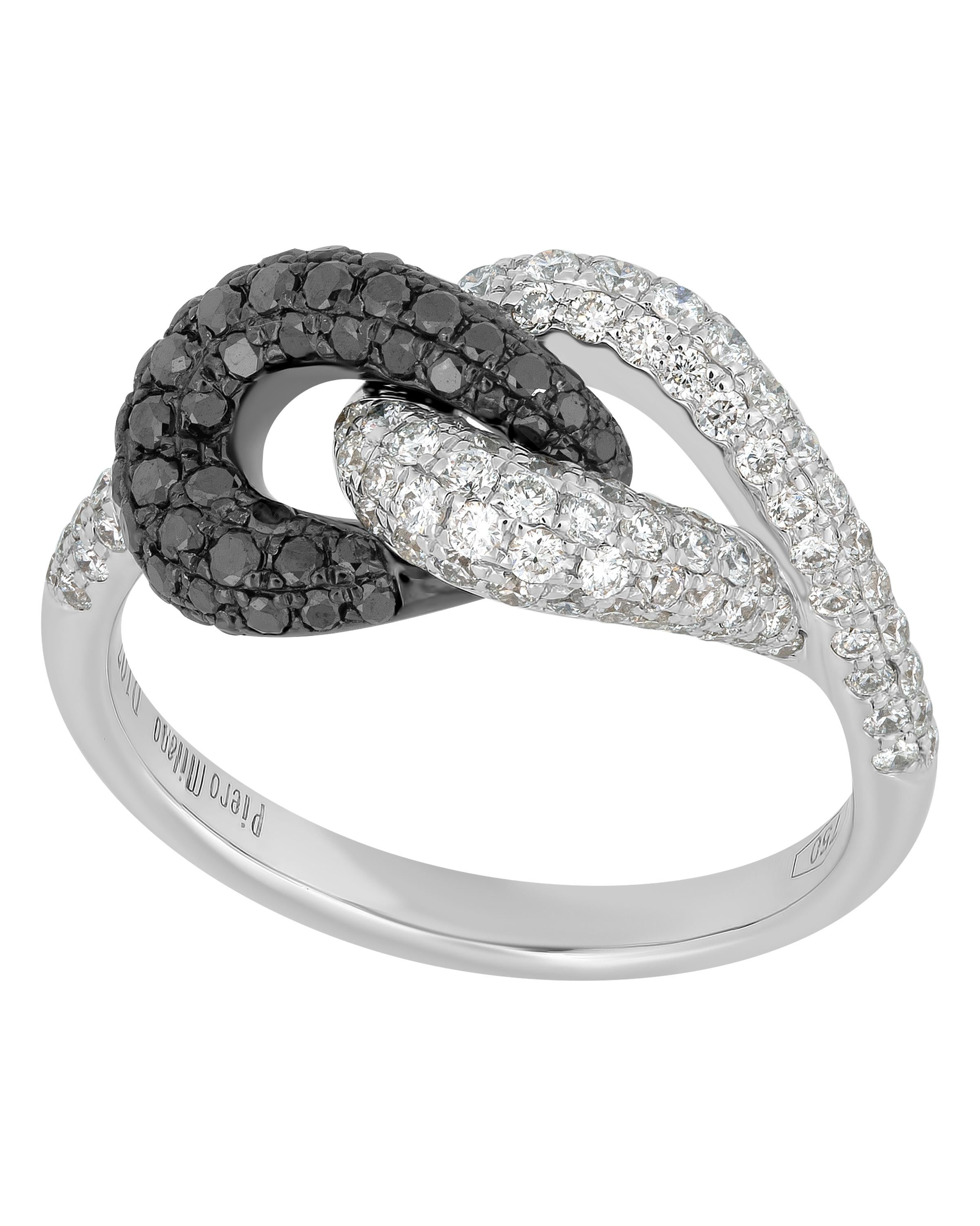 This contemporary Piero Milano 18K White Gold and 18K Black Gold Knot Ring features glittering white diamonds 0.62ct. tw. beautifully intertwined with a ring of black diamonds 0.45ct. tw. . The ring size is 7 (54.4). The Decoration Size is 9.6mm.
