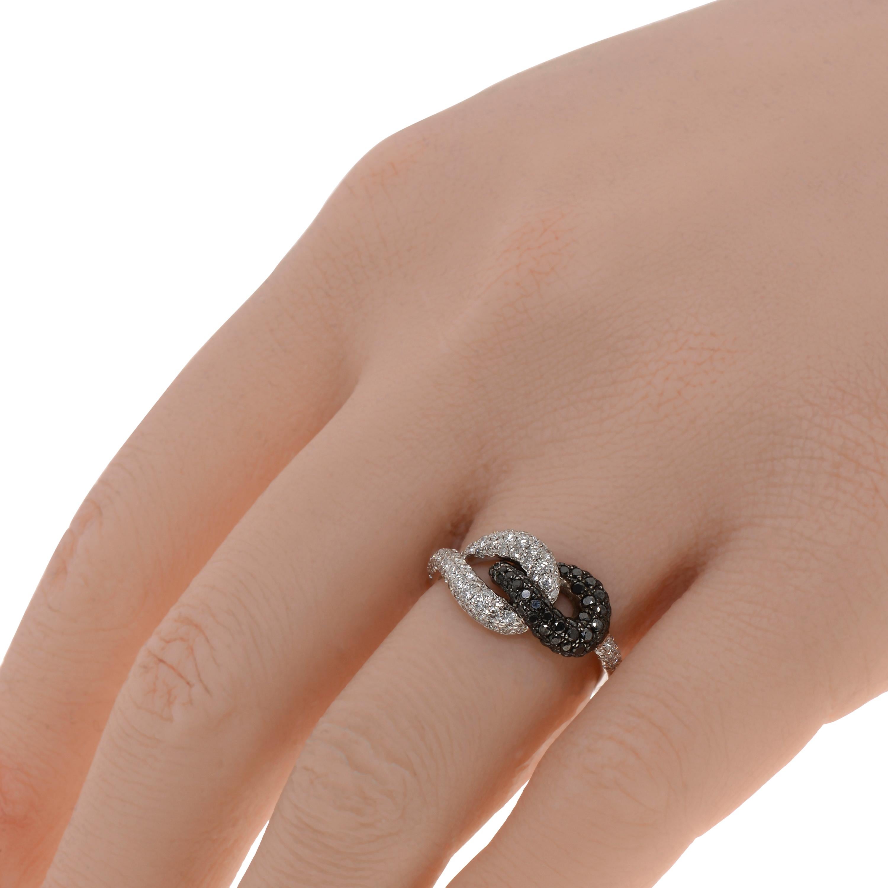 This contemporary Piero Milano 18K White Gold and 18K Black Gold Knot Ring features glittering white diamonds 0.62ct. tw. beautifully intertwined with a ring of black diamonds 0.45ct. tw.. The ring size is 6 (51.9). The Decoration Size is 9.5mm. The