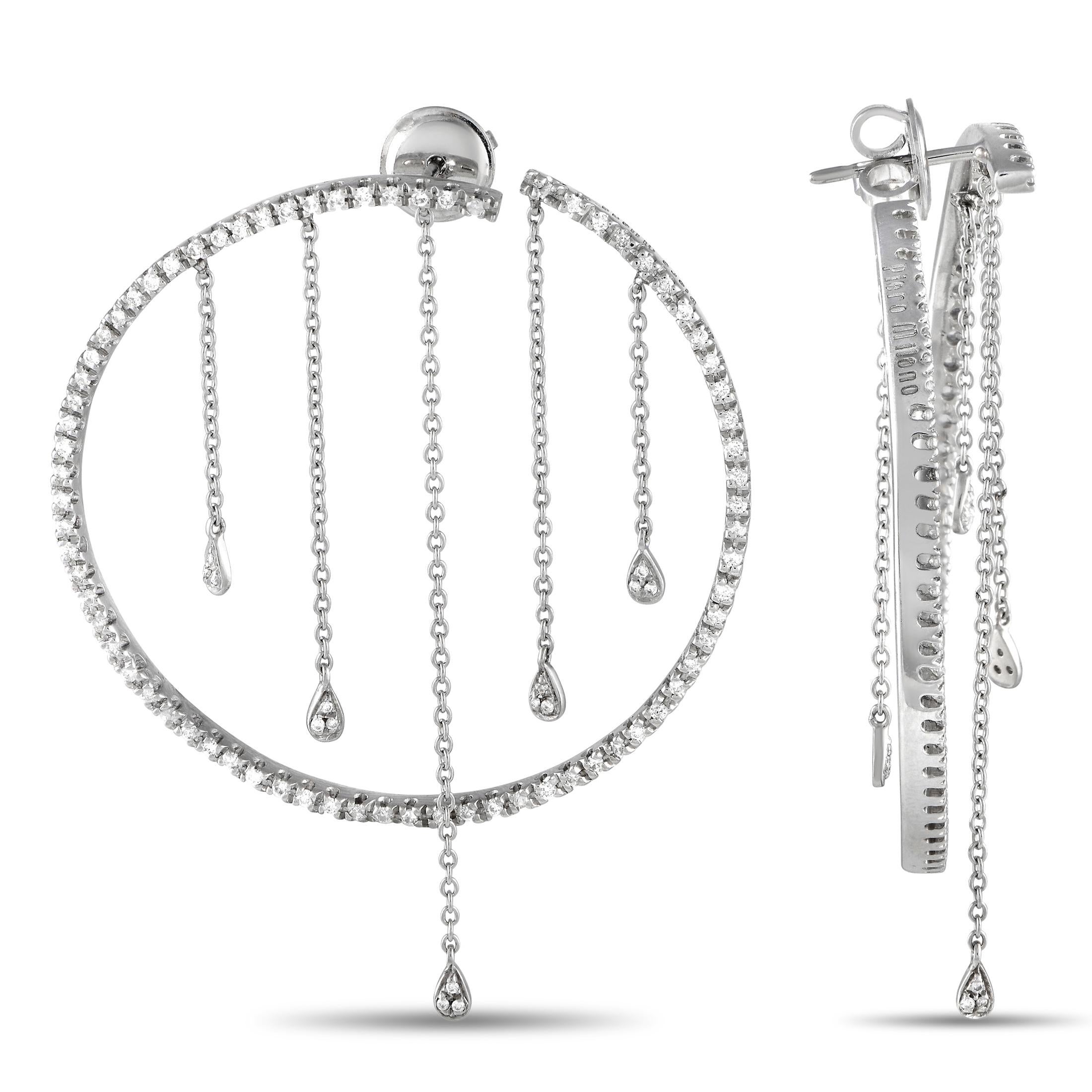 Make a sparkling statement by adding these Piero Milano to any ensemble. Crafted from 18K white gold, each one features a circular setting measuring 1.75” round. Dangling chains give them a surprising sense of movement, while diamonds totaling 1.10