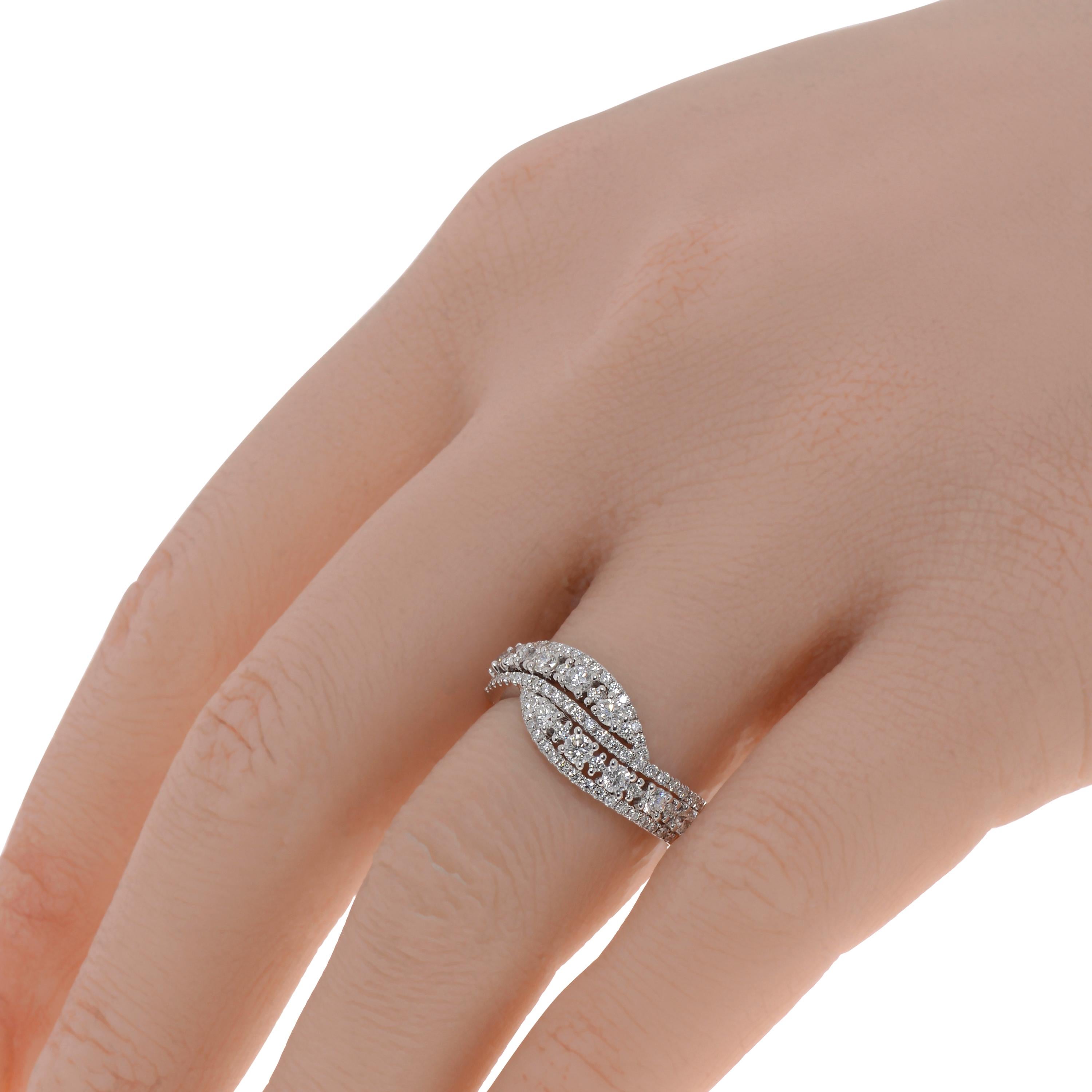 This show-stopping Piero Milano 18K White Gold Crossover Ring features glistening waves of pave elevated with shiny centers of prong set diamonds 0.76ct. tw.. The ring size is 6.25 (52.5). The Band Width is 8.1mm. The Weight is 4.3g. Diamond Color: