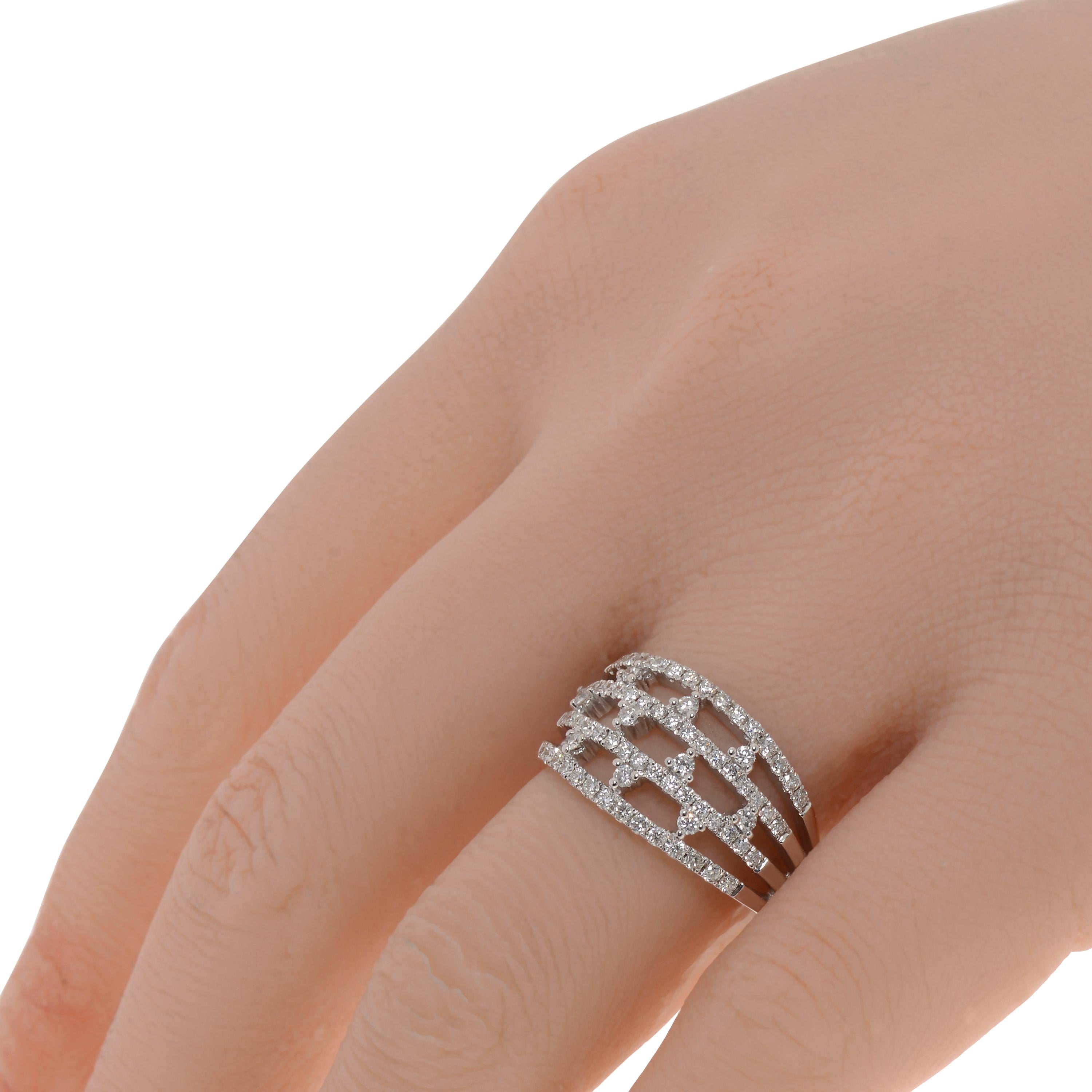 This gorgeous Piero Milano 18K White Gold Band Ring features four layers of glittering pave diamonds detailed with shining centers of prong set diamonds 0.71ct. tw. The ring size is 6.5 (53.1). The Band Width is 11.5mm. The Weight is 5.8g.
