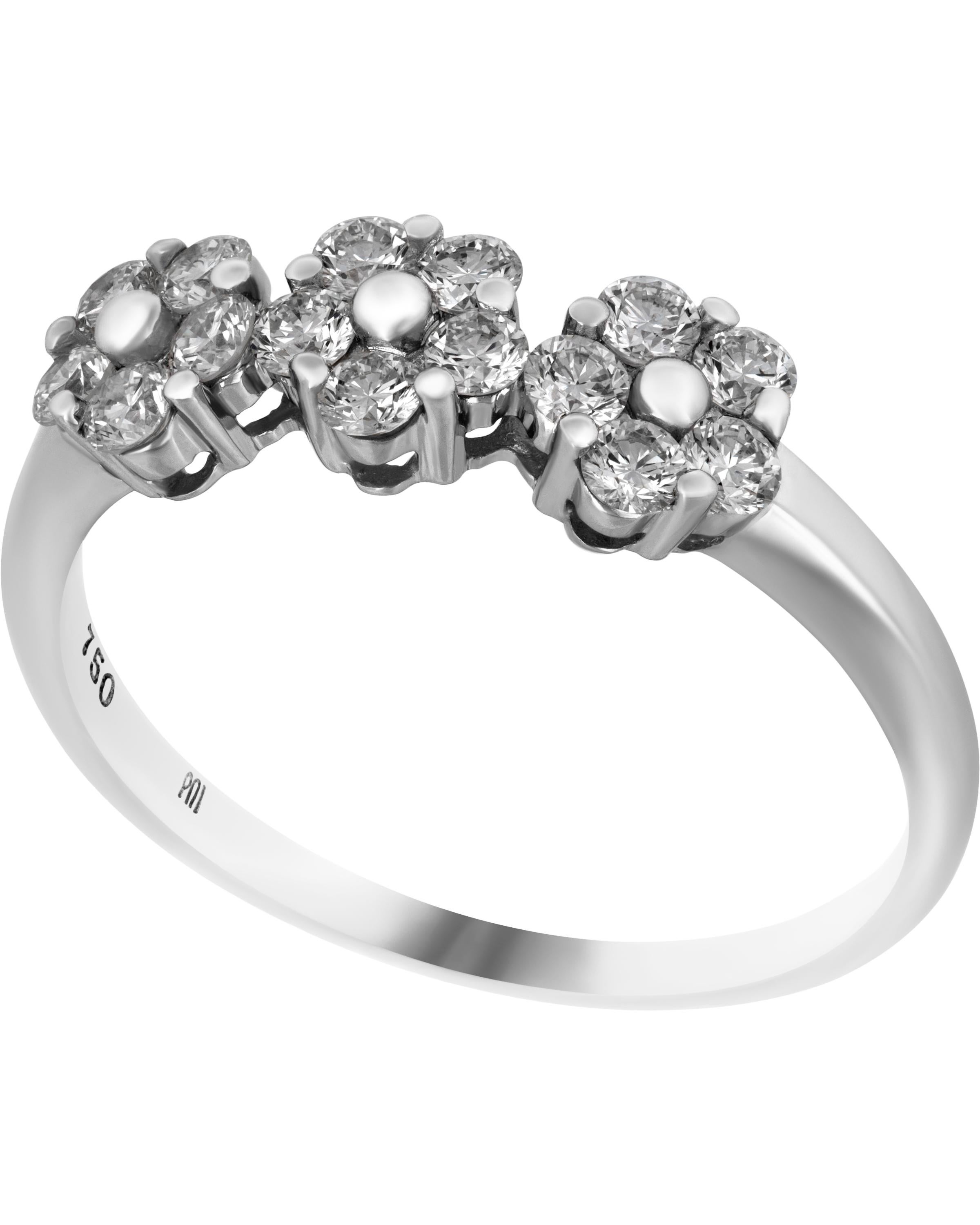 This beautiful Piero Milano 18K White Gold Band Ring features three luscious diamond flowers 0.53ct. tw. adorned with a beaded center of 18K White Gold. The ring size is 6.75 (53.8). The Band Width is 2.5mm. The Weight is 2.2g. Diamond Color: G-H.