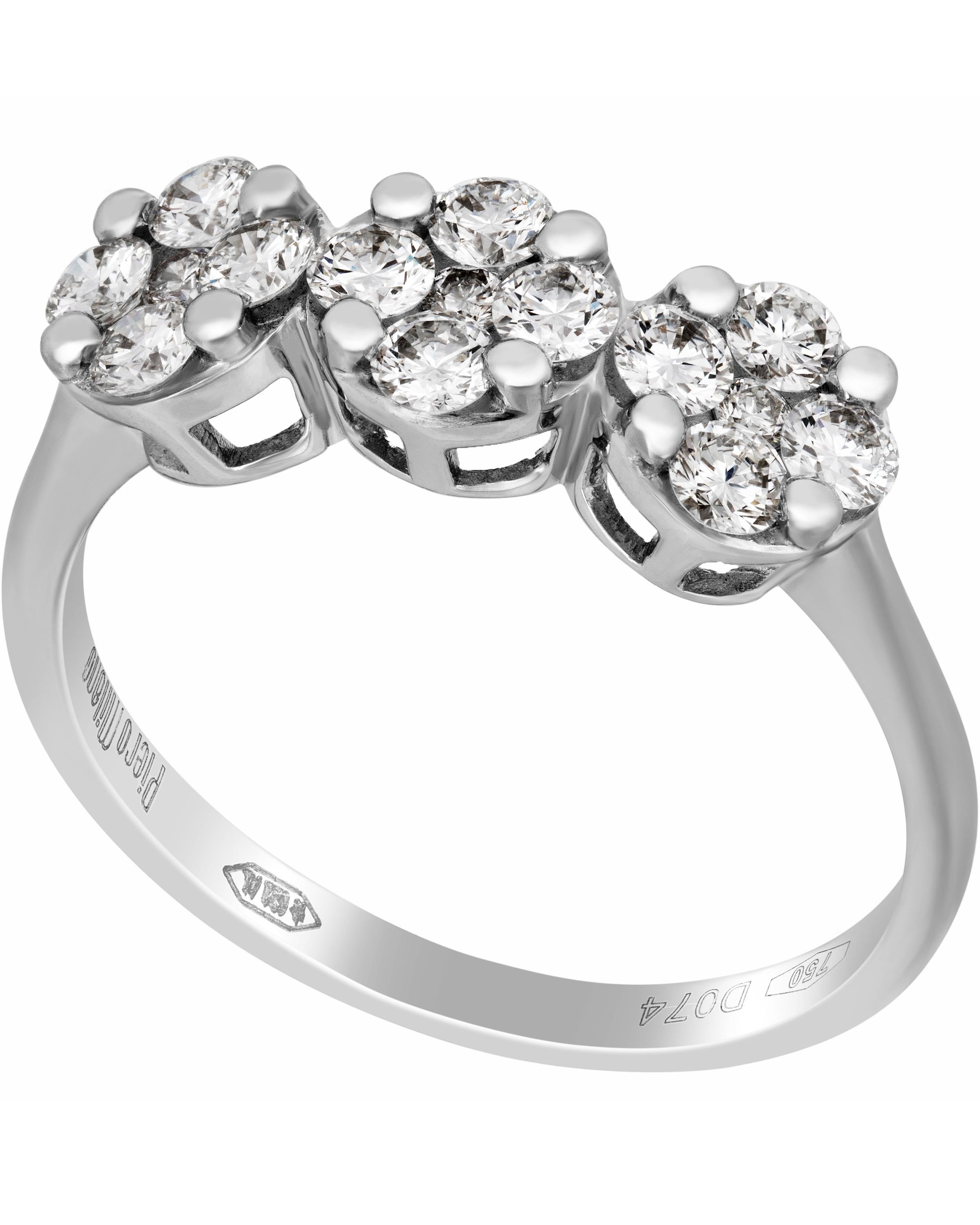 This beautiful Piero Milano 18K White Gold Band Ring features three glistening diamond flowers adorned with a gleaming center 0.74ct. tw. . The ring size is 7.25 (55.1). The Band Width is 2.5mm. The Weight is 2.9g. Diamond Color: G-H. Diamond