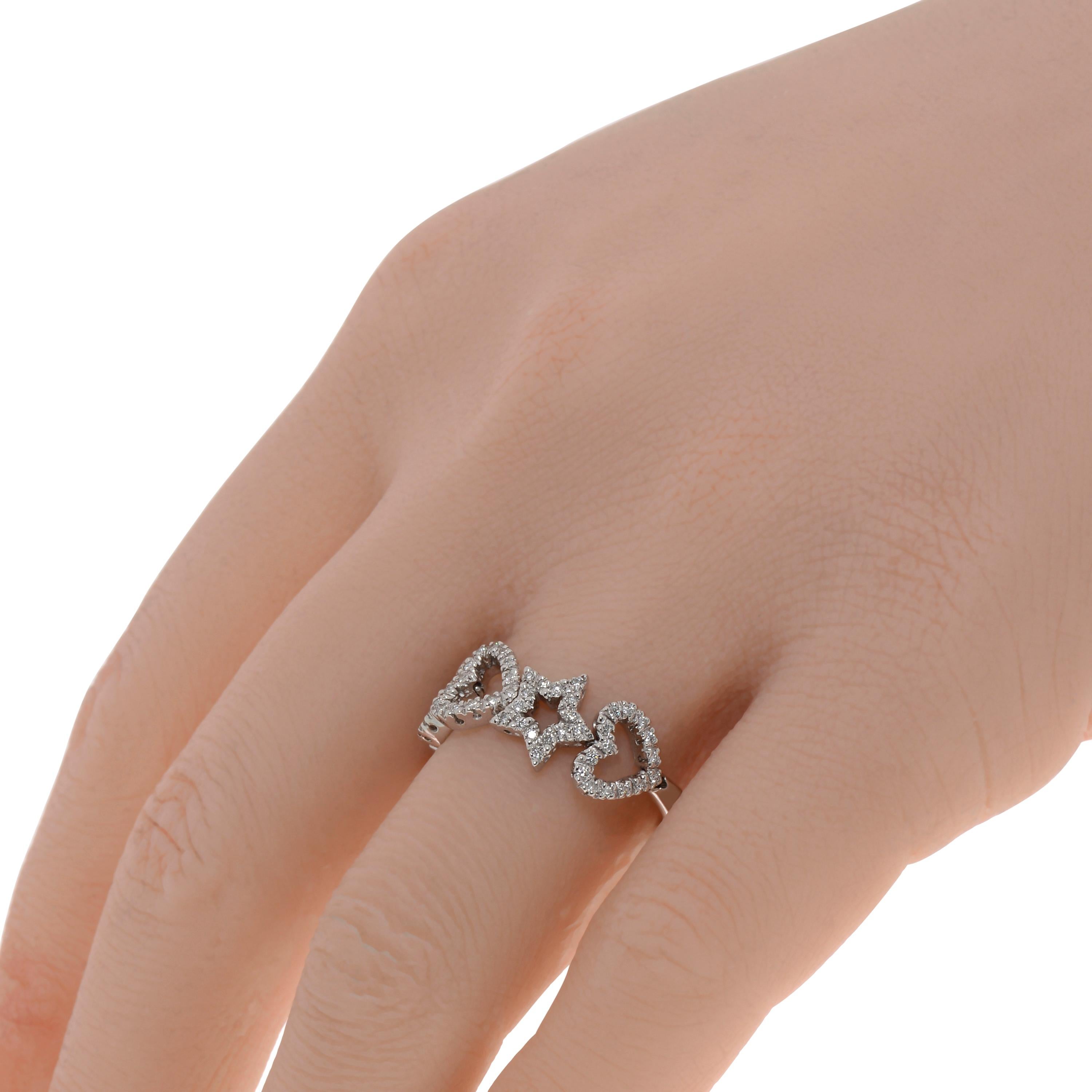 This playful Piero Milano 18K White Gold Band Ring features open work designs adorned with glittering diamonds 0.28ct. tw. in a shared prong setting. The ring size is 7.5 (55.7). The Band Width is 8.1mm. The Weight is 6.3g. Diamond Color: G-H.