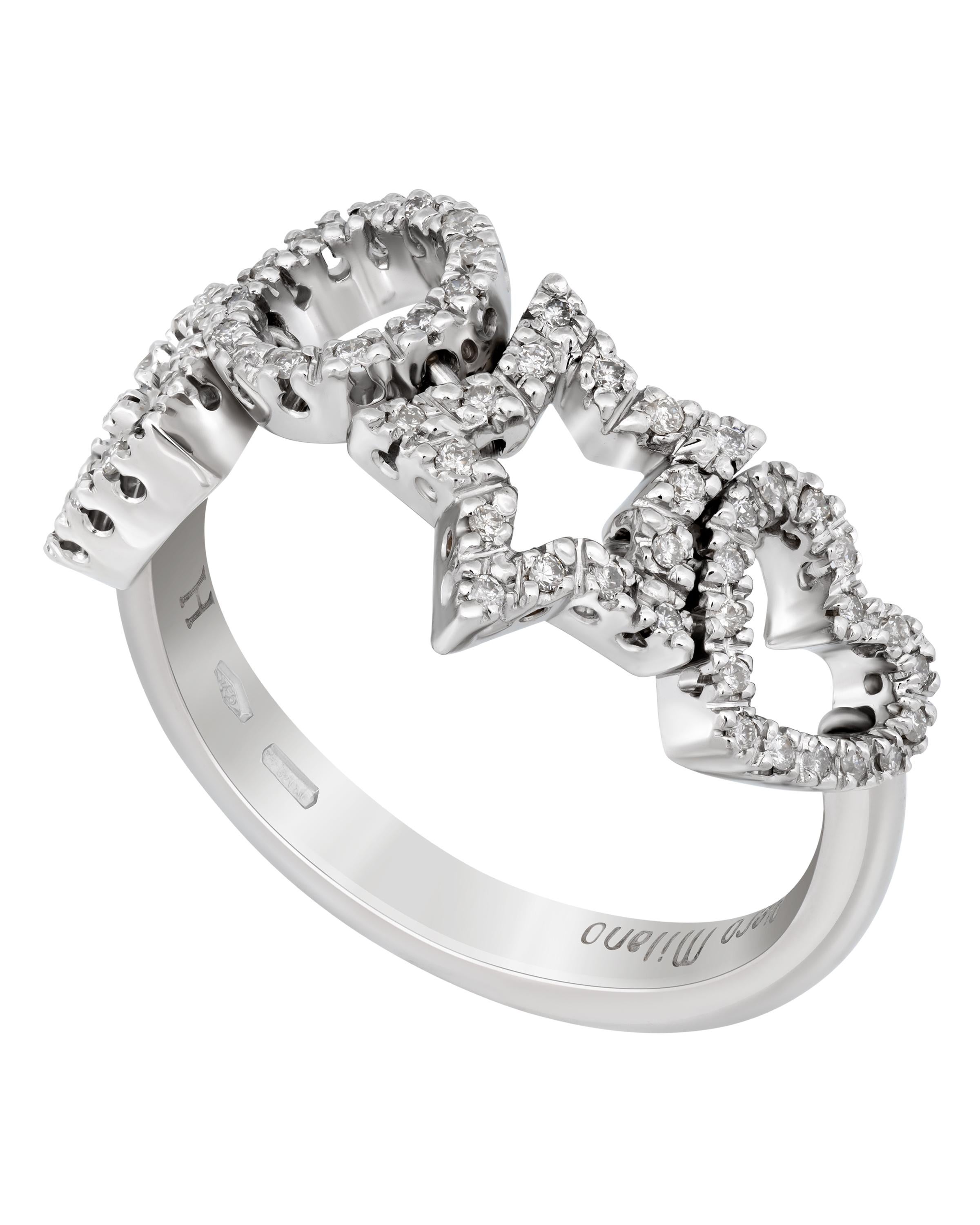 This playful Piero Milano 18K White Gold Band Ring features open work designs adorned with glittering diamonds 0.23ct. tw. in a shared prong setting. The ring size is 7.75 (56.3). The Band Width is 7.7mm. The Weight is 6.9g. Diamond Color: G-H.