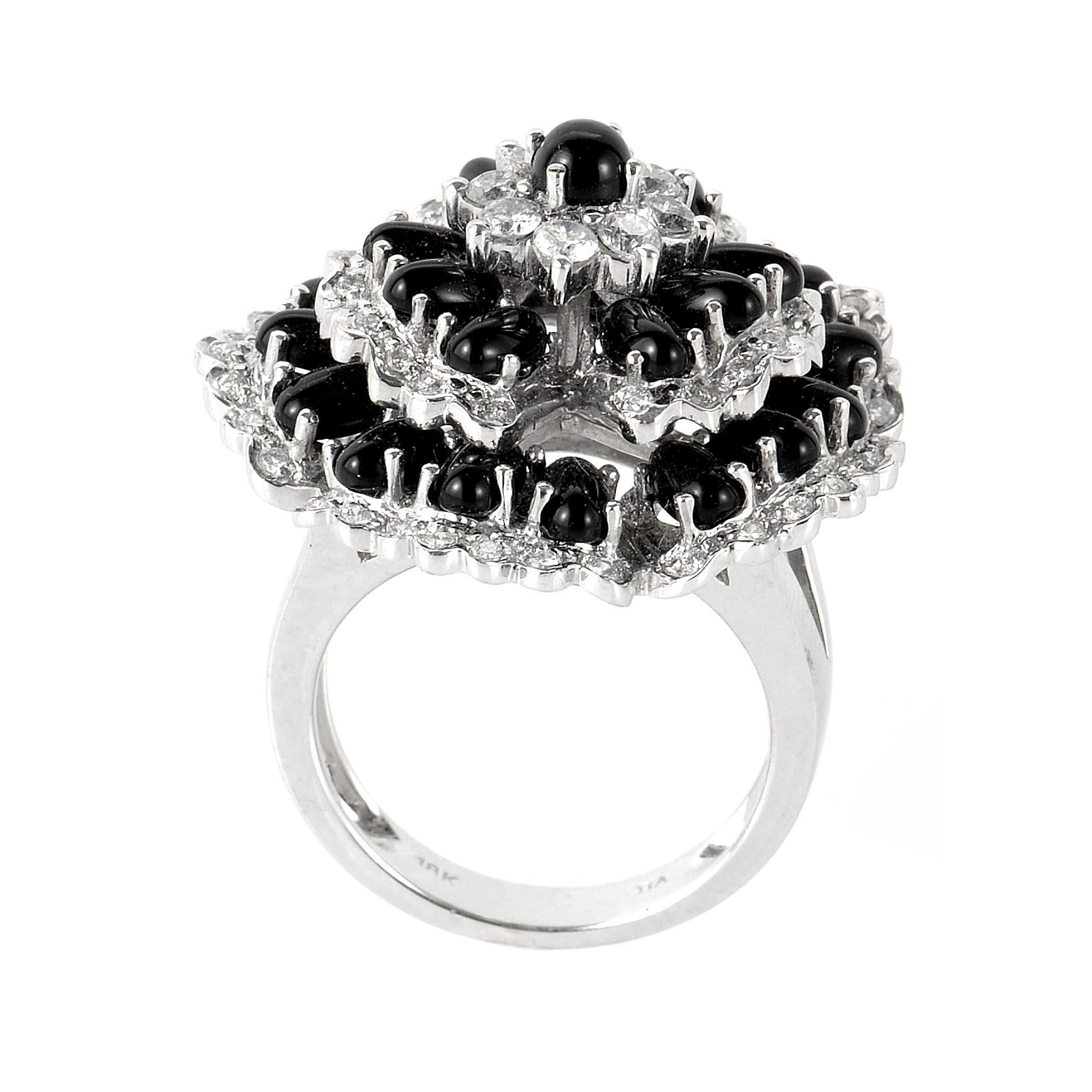 This ring is opulent and shines with diamonds. This fabulous ring is made of 18K white gold and is made to look like a flower. The flower is set with ~.83ct of diamonds and onyx beads. 
Ring Size: 6.75