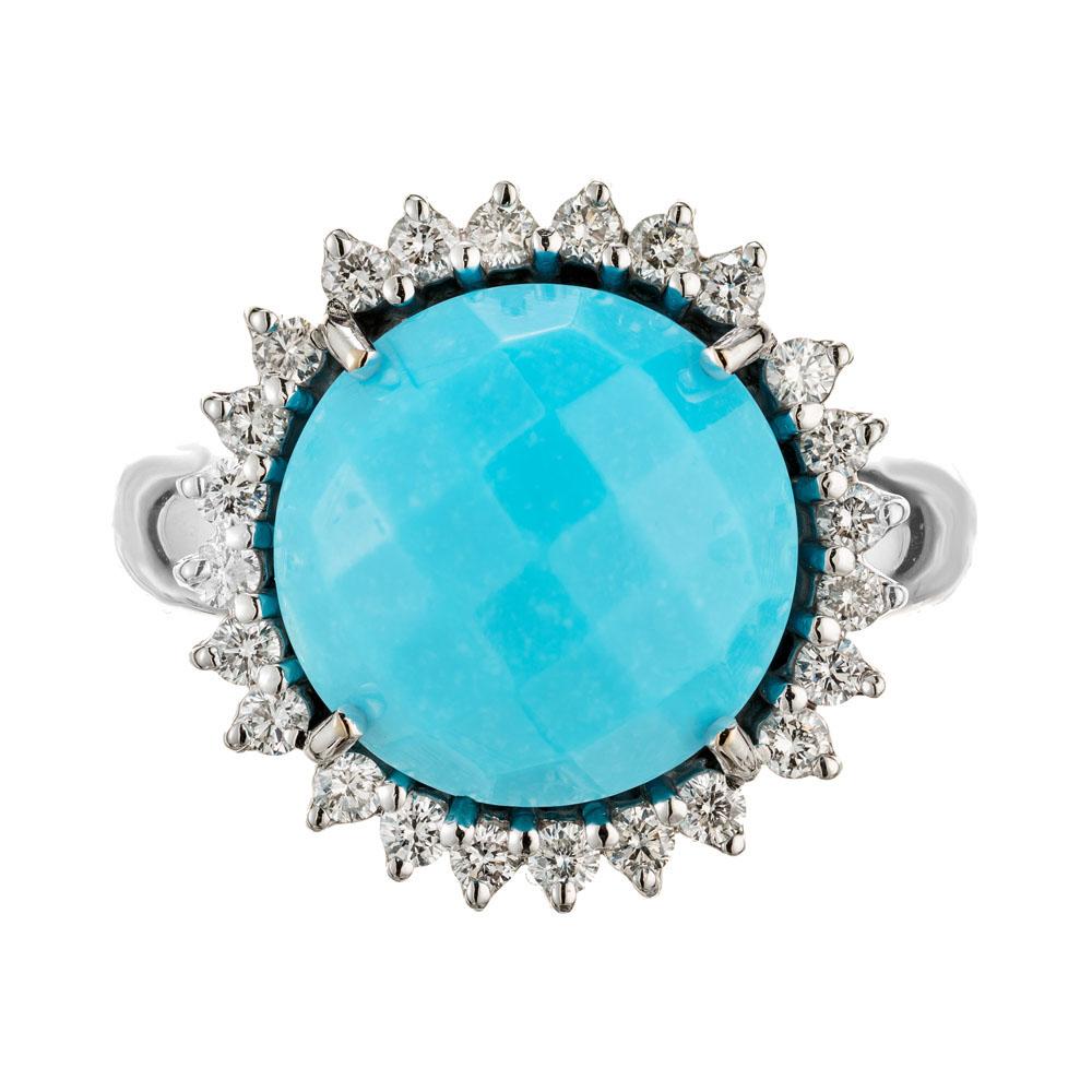 Estate Piero Milano 18k white gold ring with a bright turquoise surrounded by beautiful white natural sparkly diamonds. Mounted with a 12.23mm faceted untreaded turquoise with a halo of 24 round cut diamonds. The ring has an intricately crafted