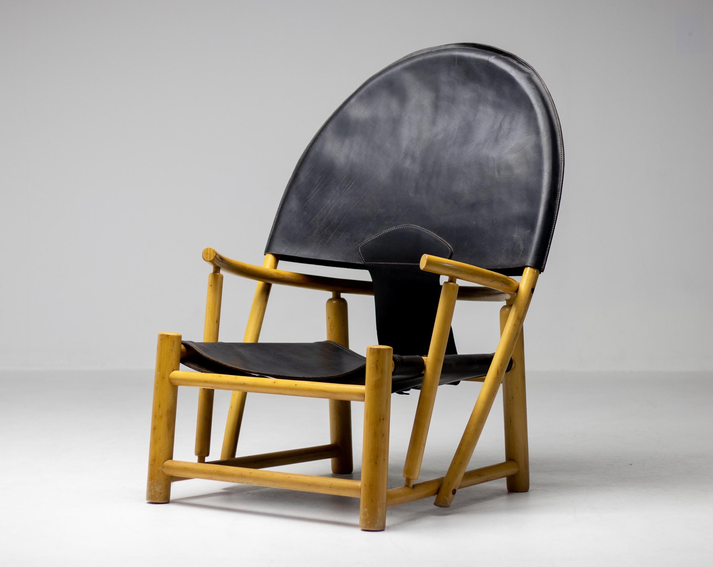 Oversized and huge on character and style this G23 Hoop chair design by Piero Palange and Werther Toffoloni for Germa, Italy is truly a masterpiece. An elegant curvaceous solid maple frame combined with beautifully patinated black saddle leather