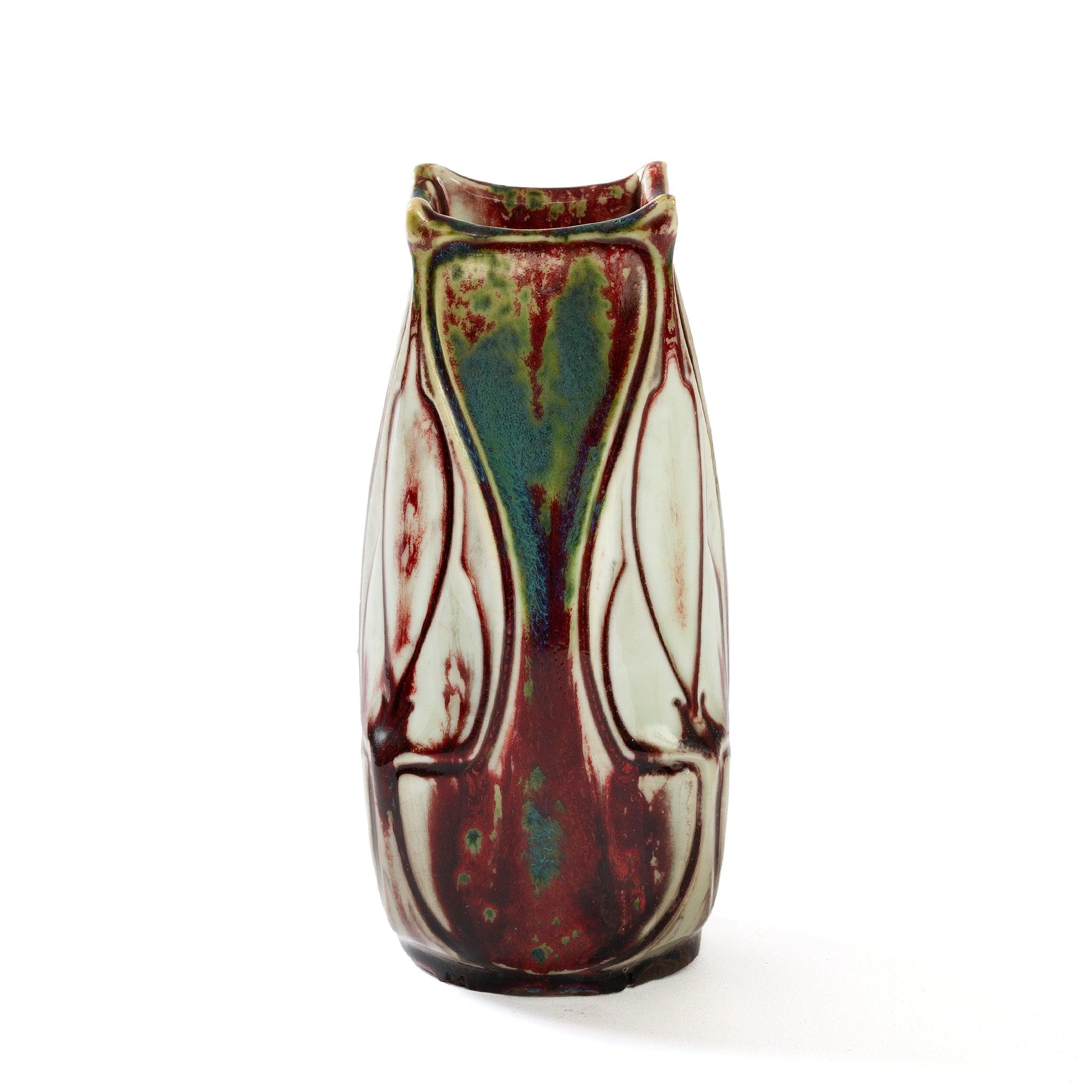 Pierre-Adrien Dalpayrat's signature ruby-cranberry-crimson glaze is at the forefront of this exciting composition, an arresting design featuring strong color contrast, irregular borders and sweeping lines. The vase is speckled throughout with teal