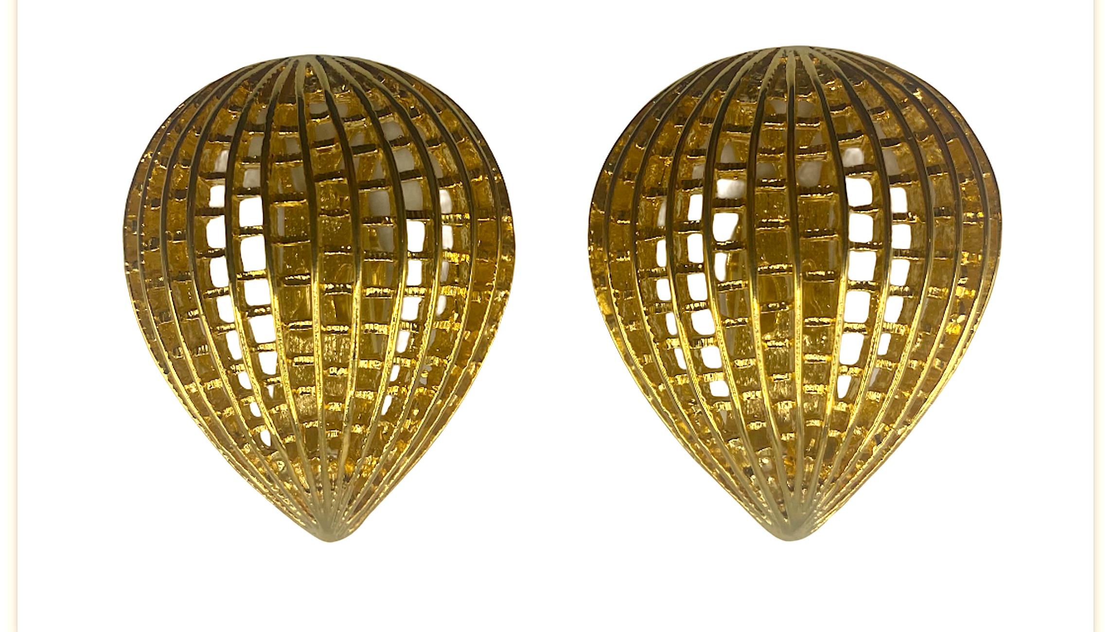 Presented is a classic and yet modern design pair of earrings by famous fashion house Pierre Balmain. Each clip earring is a large 1.38 inches wide, 1.75 inches long and .5 of an inch deep. They are a dome pear shape with an openwork net like design