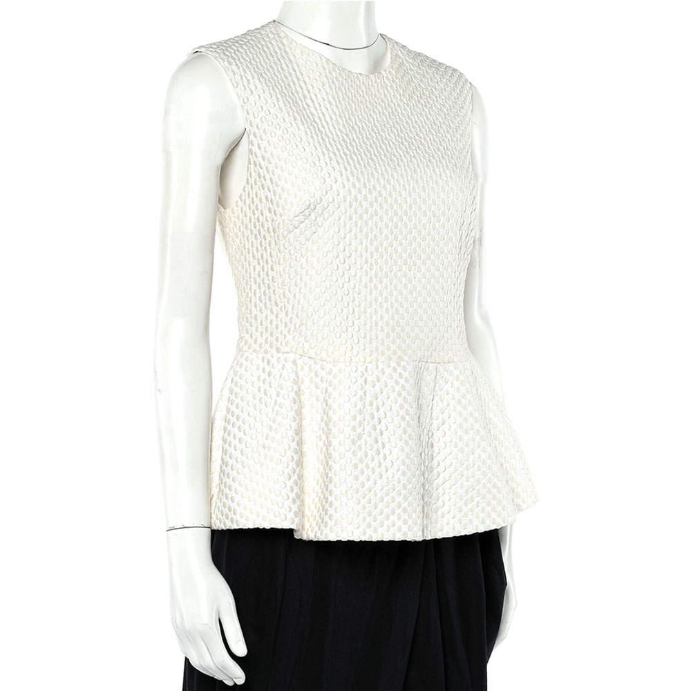 This top from Pierre Balmain exhibits smart tailoring and a delicate design. This sleeveless top, made of embroidered fabric, this cream top features a flattering peplum silhouette. Completed with a round neckline, wear this with cropped, fitted
