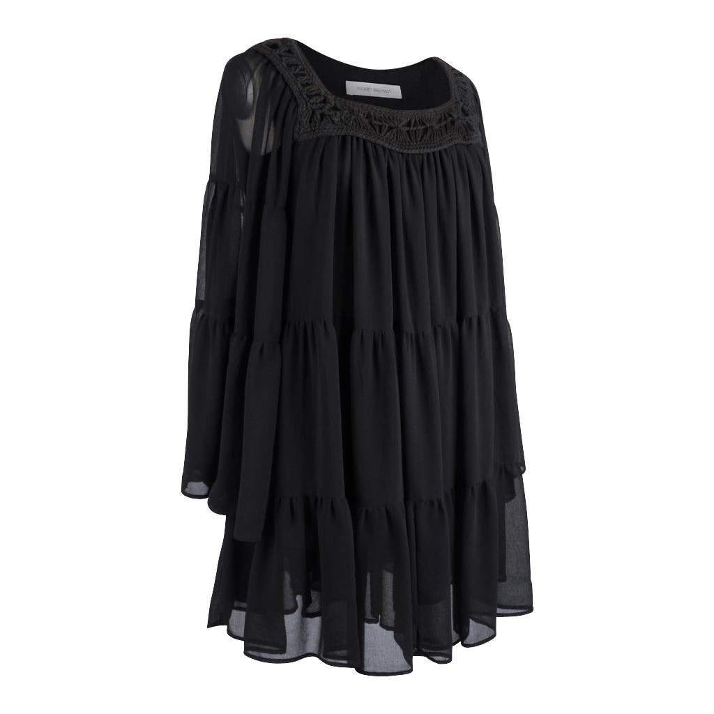 Guaranteed authentic Pierre Balmain black flouncy tiered dress.
Square neckline with macrame detail.
Dress has 3 tiers.
Sleeves bell with 3 tiers as well.
Pull on dress.
Fabric is polyester georgette.


SIZE  40
USA SIZE  6

DRESS MEASURES:
LENGTH 