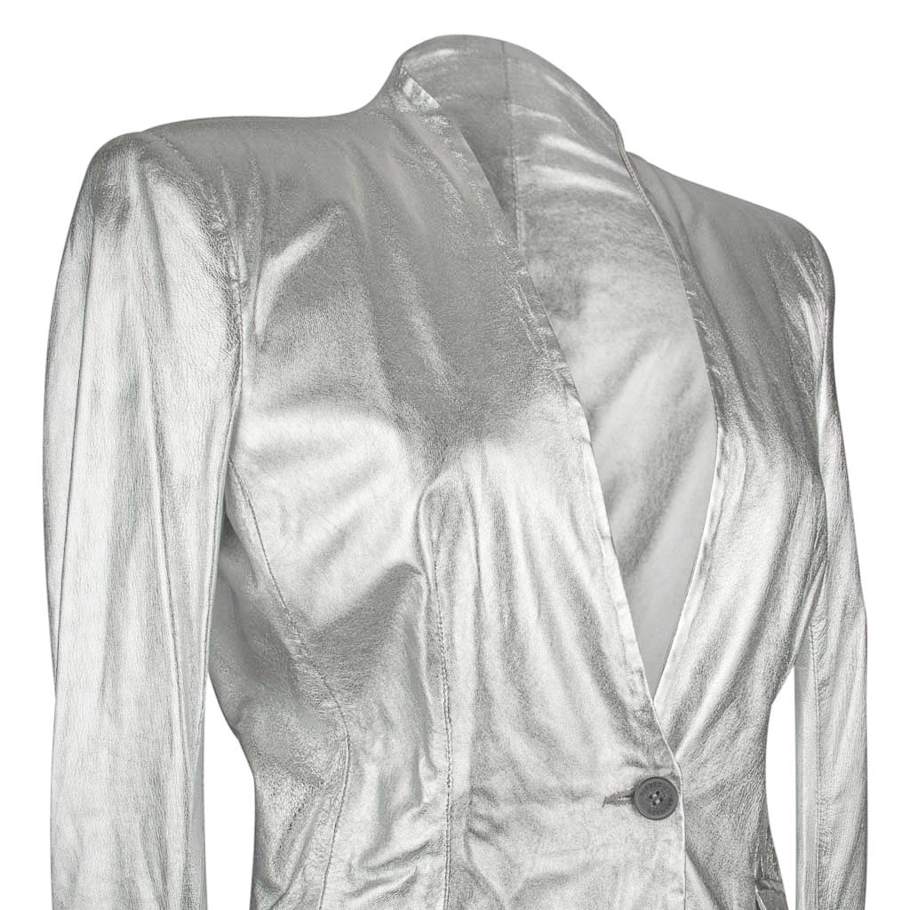Mightychic offers a Pierre Balmain brilliant silver whisper light leather jacket with deep V and no lapels.
1 Button single breast with 2 flap pockets.
4 working buttons on each cuff.
All buttons are embossed Pierre Balmain.
NEW or NEVER WORN -