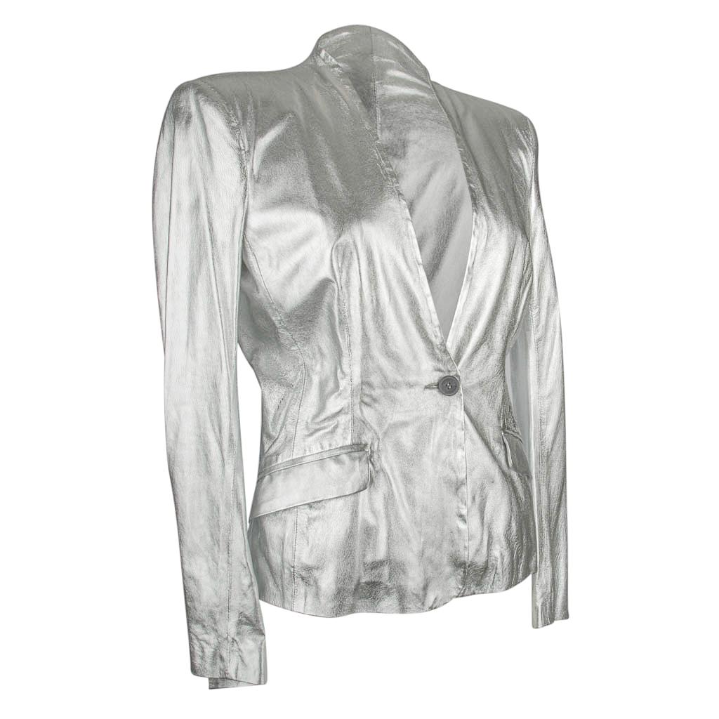 Mightychic offers a Pierre Balmain brilliant silver whisper light leather jacket with deep V and no lapels.
1 Button single breast with 2 flap pockets.
4 working buttons on each cuff.
All buttons are embossed Pierre Balmain.
NEW or NEVER WORN -
