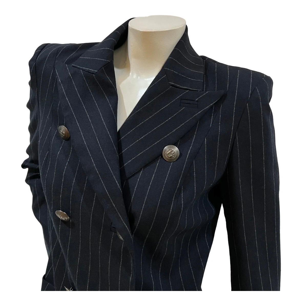 Designer Pinstripe Jacket by Pierre Balmain   
Circa 2010
Dark navy blue with white pinstripes throughout 
Double breasted front closure
Silver-tone metal logo buttons
Four logo buttons on each cuff 
Shoulder pads
Dual front hip pockets
74% wool,
