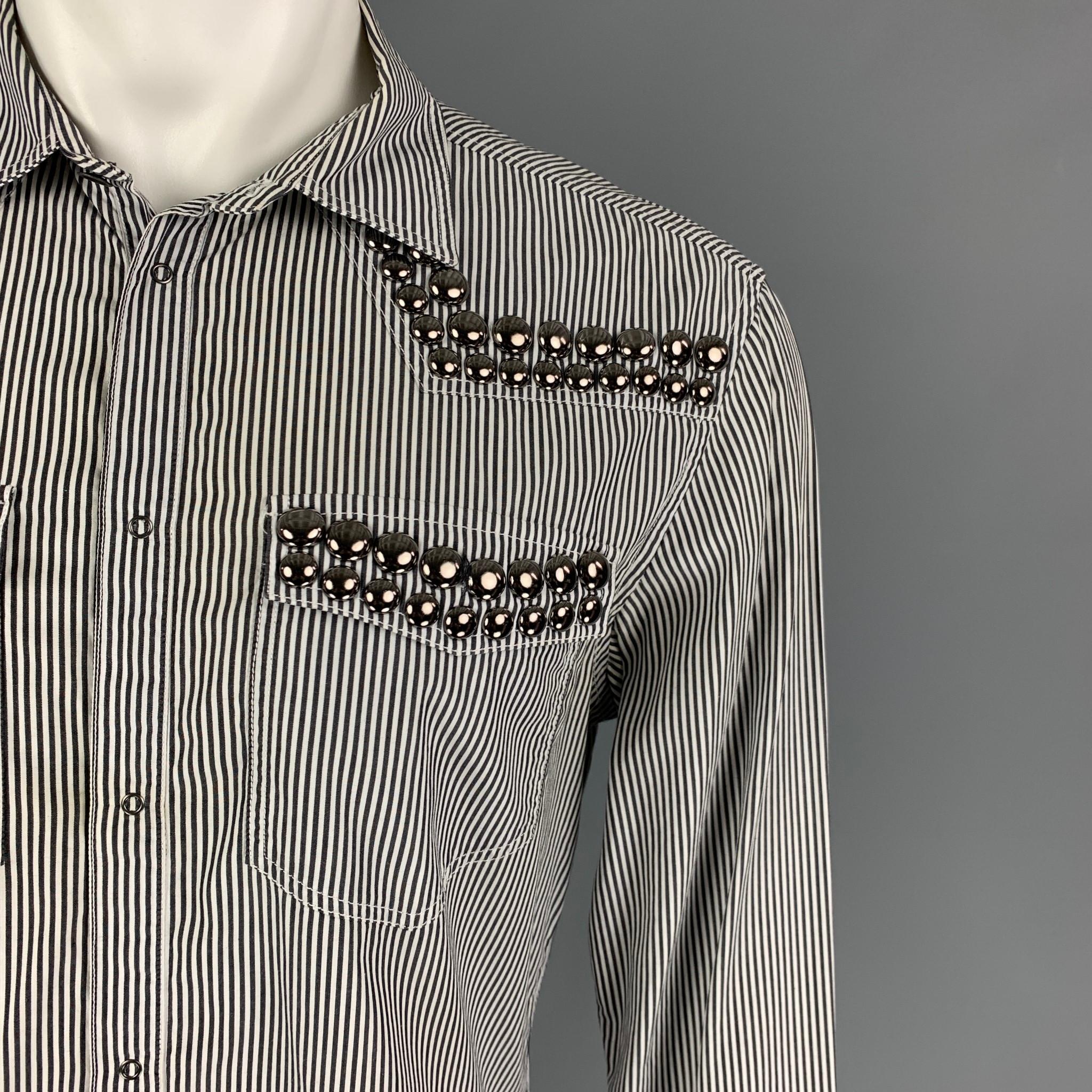 PIERRE BALMAIN long sleeve shirt comes in a black & white stripe cotton featuring studded details, spread collar, and a snap button closure. Made in Italy.

Very Good Pre-Owned Condition.
Marked: 36/50

Measurements:

Shoulder: 19 in.
Chest: 40