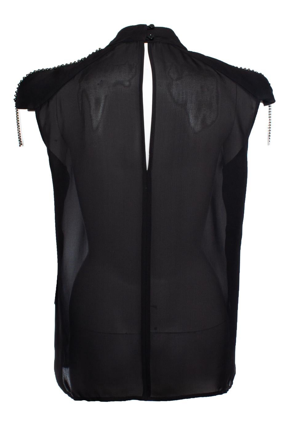 Pierre Balmain, top negro semitransparente con hombreras y decoración en los hombros. El artículo está en muy buen estado. Las etiquetas se recortan en la parte superior.

- ESTADO: muy buen estado 

- TALLA: FR38 - S 

- MEDIDAS: largo 64 cm, ancho