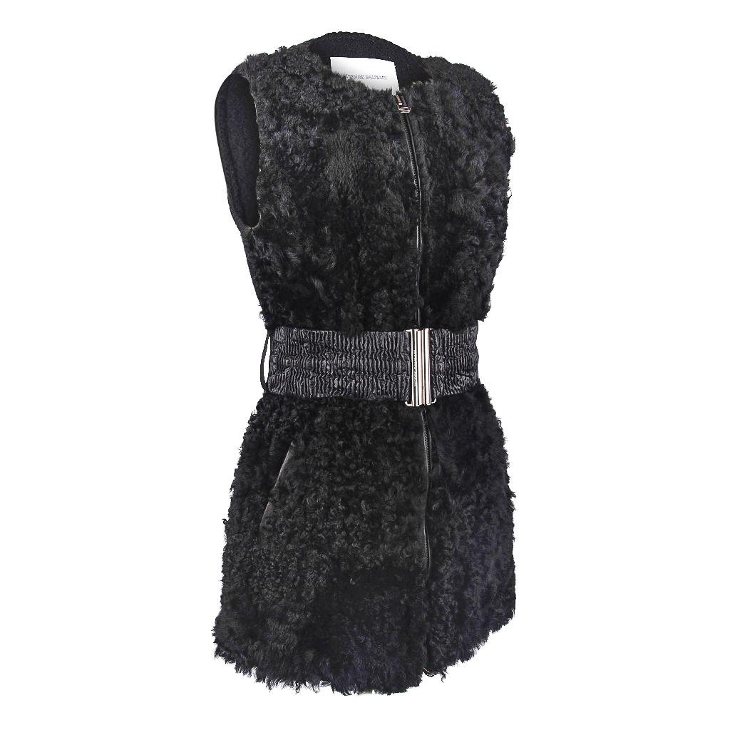 Guaranteed authentic Pierre Balmain black lambskin long line vest with shearling front.
Sleeveless vest with a wide ruched elasticized belt.
Vest is trimmed in leather.
Double toggle zipper front.
2 hidden slot pockets at sides.
Rear is textured