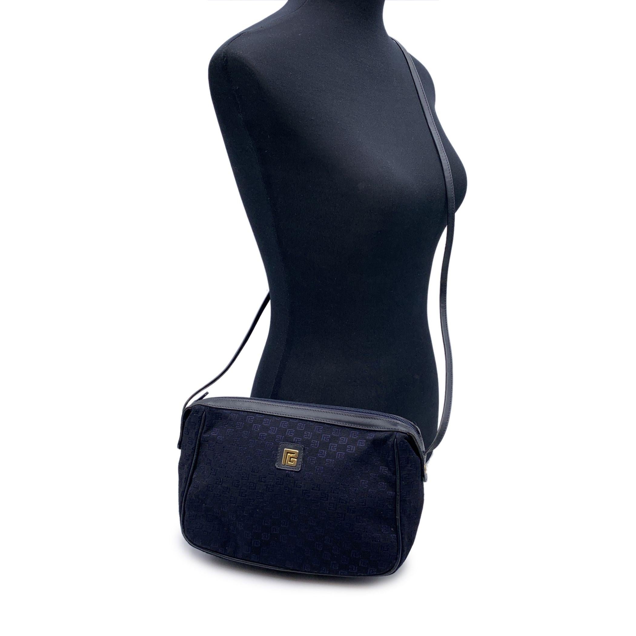 Vintage Pierre Balmain shoulder bag in blue monogram canvas and leather. Gold metal logo plate on the front. Upper zipper closure. Black lining. Adjustable shoulder strap. 'PIERRE BALMAIN Paris' tag inside Condition B - VERY GOOD Gently used. Please