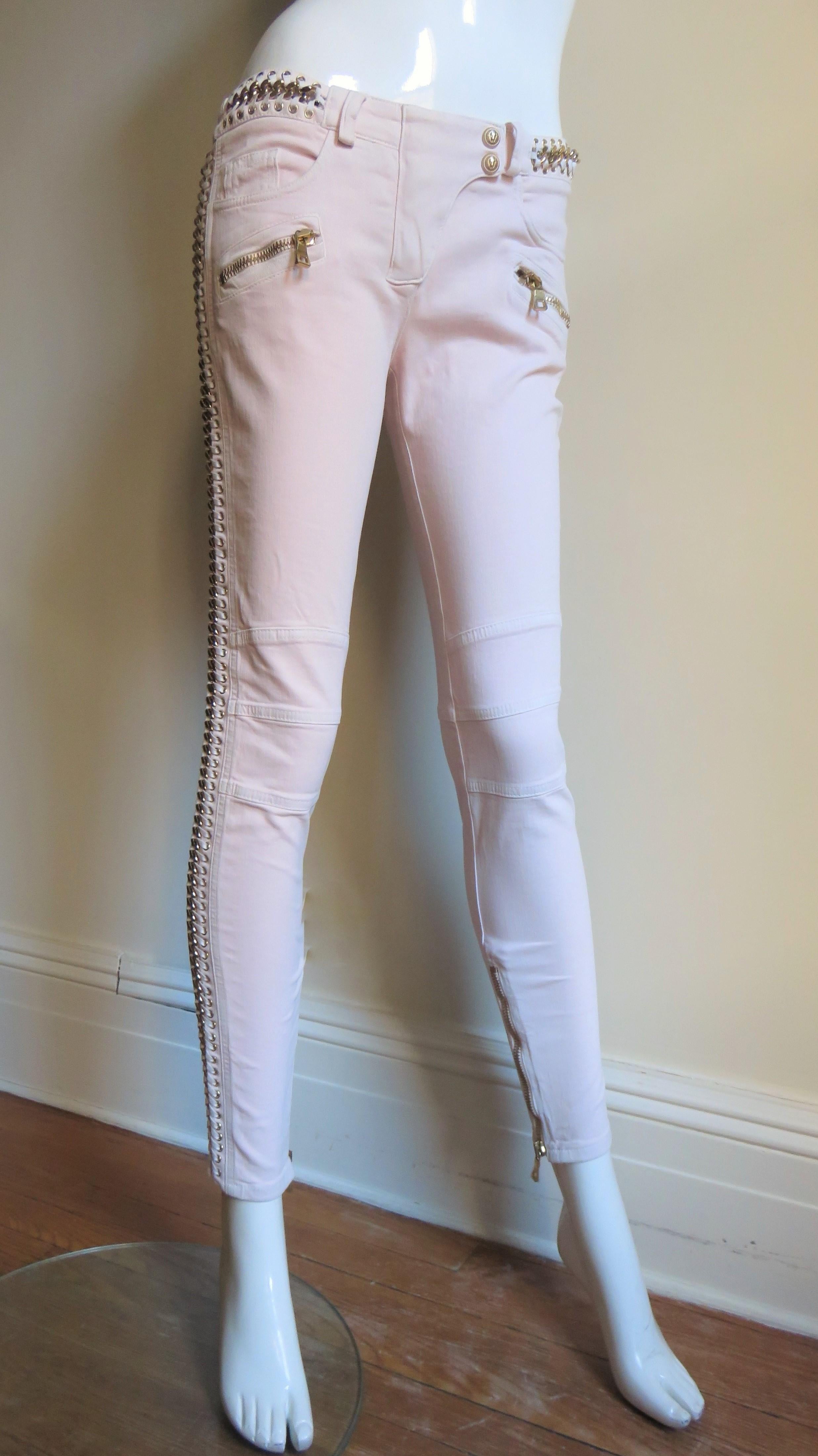 Fabulous baby pink cotton denim jeans with a bit of stretch from Balmain.  It has the Balmain jean signature horizontal seaming at the knees, 5 front pockets including zipper pockets, 2 zipper back pockets and zippers at the ankles of the tapered