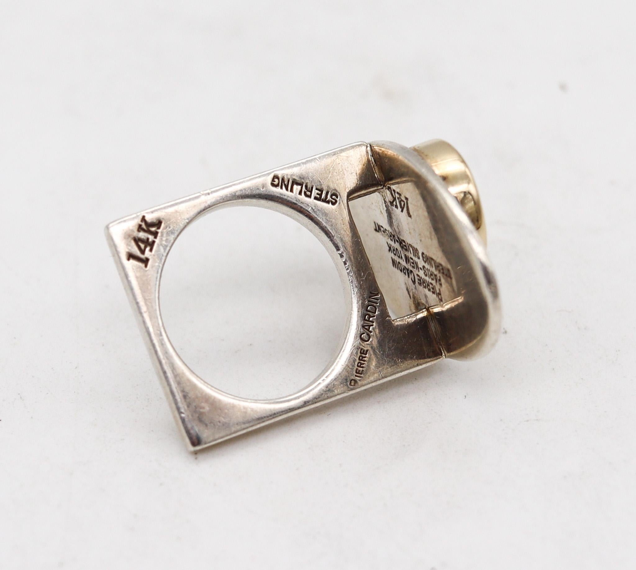 Geometric ring designed by Dinh Van for Pierre Cardin.

Sculptural modernist piece, created in France by the Parisian fashion designer Pierre Cardin, back in the 1970. This geometric sculptural ring has been crafted with minimalist patterns in solid